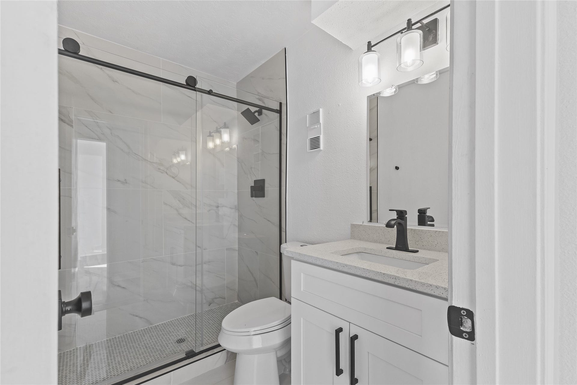 1913 Bittercreek Drive, Houston, TX 77042 The secondary bathroom includes a shower/tub combo and a well-appointed vanity, ideal for family or guests.