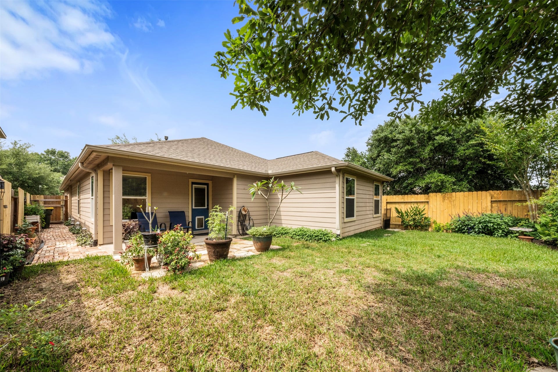 9750 Gulfstream Drive, Conroe, TX 77303 Another view of the private backyard with a cozy patio and well-kept lawn, ideal for relaxing or entertaining.
