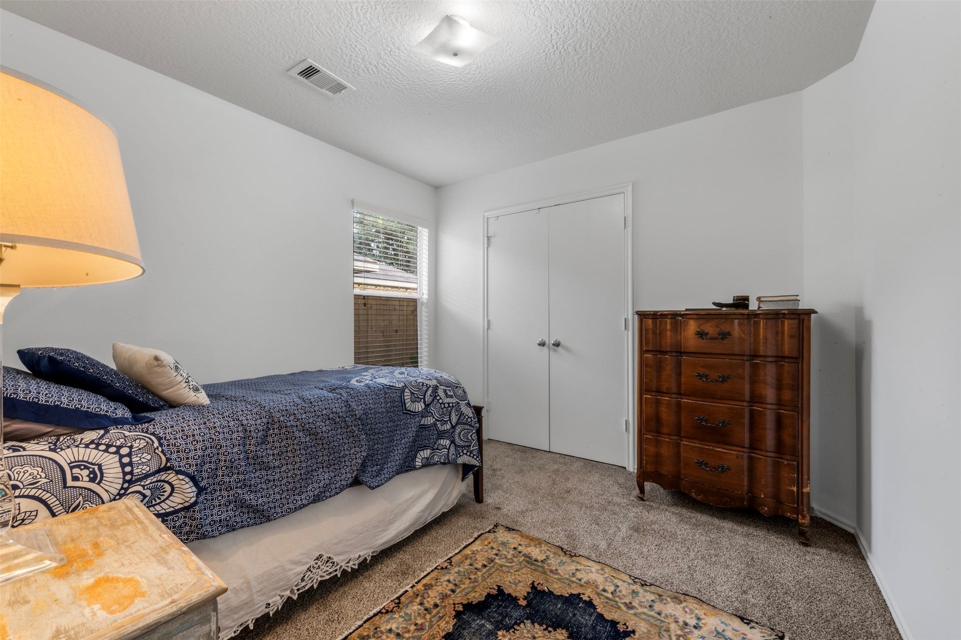 9750 Gulfstream Drive, Conroe, TX 77303 This cozy bedroom features soft carpet, double-door closet for storage and plenty of natural light.