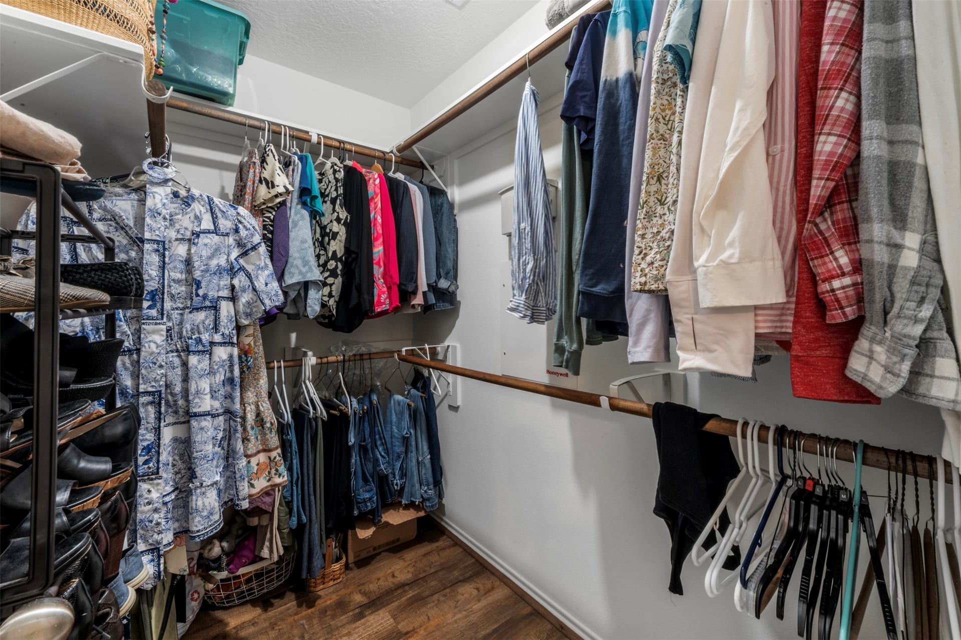 9750 Gulfstream Drive, Conroe, TX 77303 Spacious walk-in closet with ample hanging space, shelving for shoes and a hardwood floor, providing excellent storage and organization options.