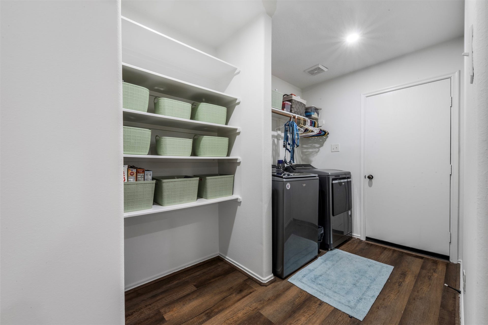 9750 Gulfstream Drive, Conroe, TX 77303 Large laundry room with modern appliances. It features ample shelving for storage. The space is well-lit and functional.