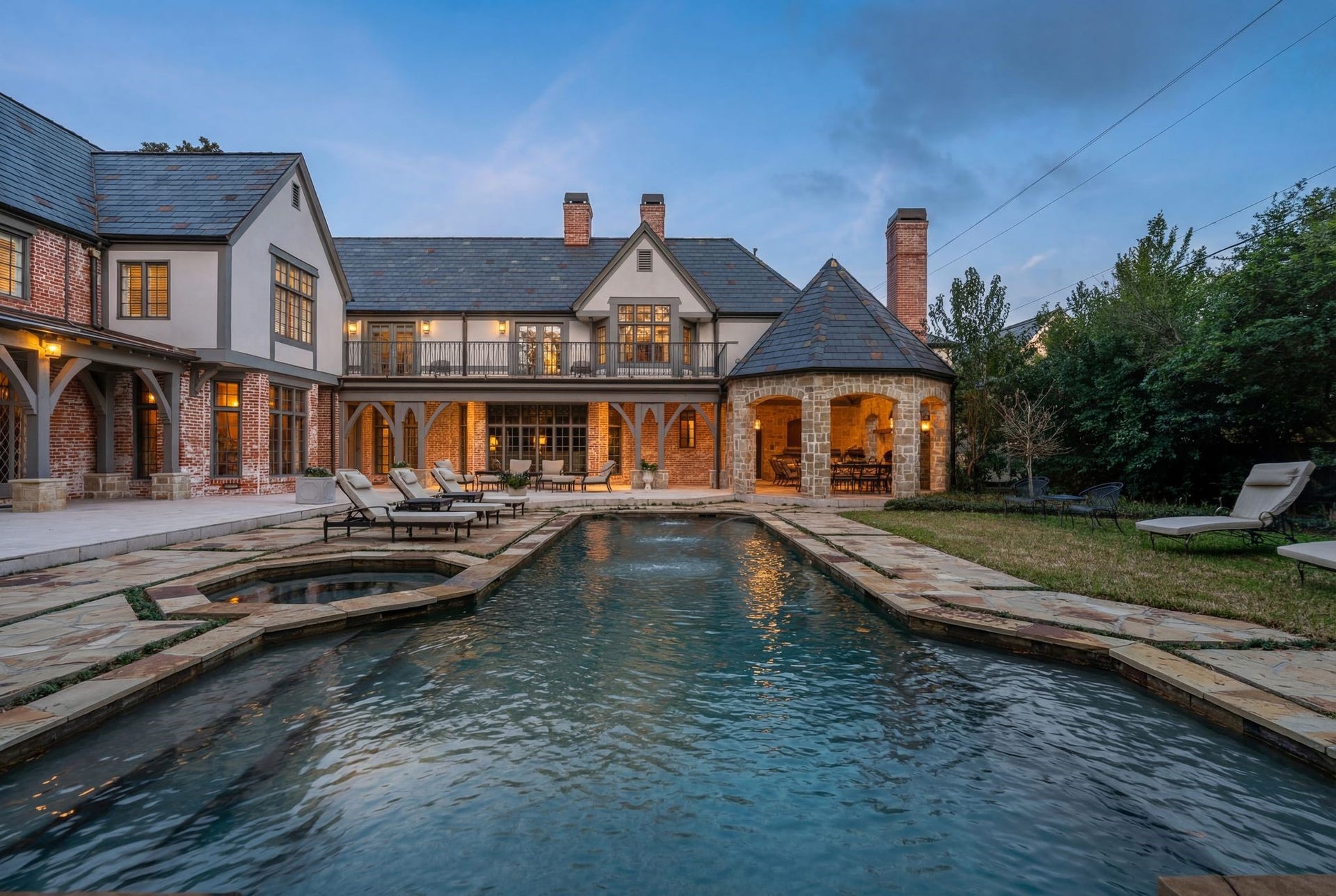 [Rear Elevation]
A photo of the patios and pool reveals the seamless addition achieved by Robert Dame Designs and Slovack-Bass Design /Build for the sellers (center rear).