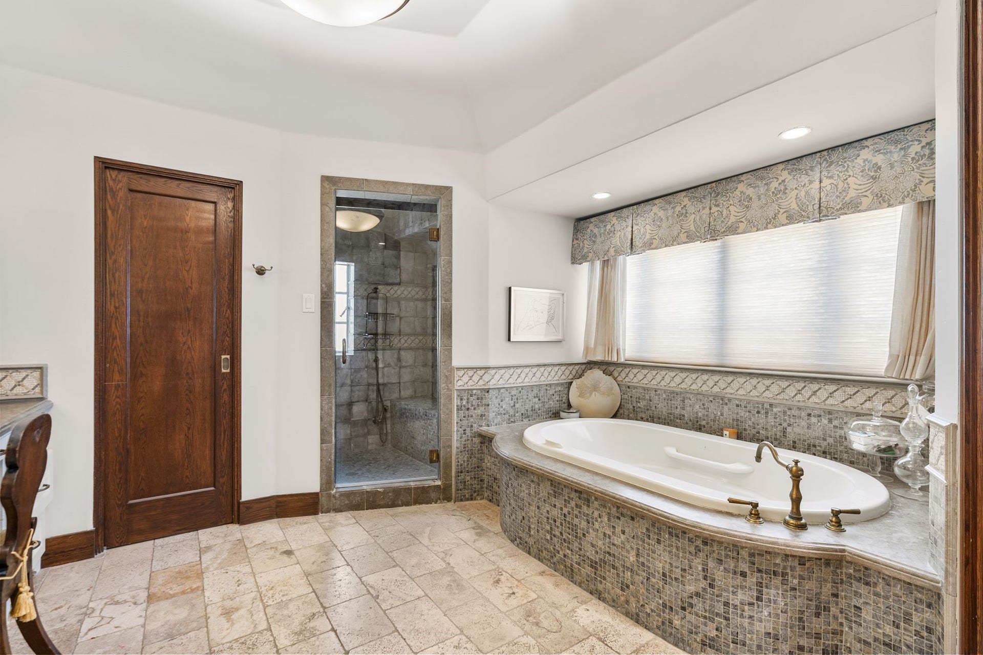 [Primary Bath #2]
This bath features an air tub with mosaic tile surround, mosaic-tiled shower, vanity (left), and a water closet with pocket door (left).