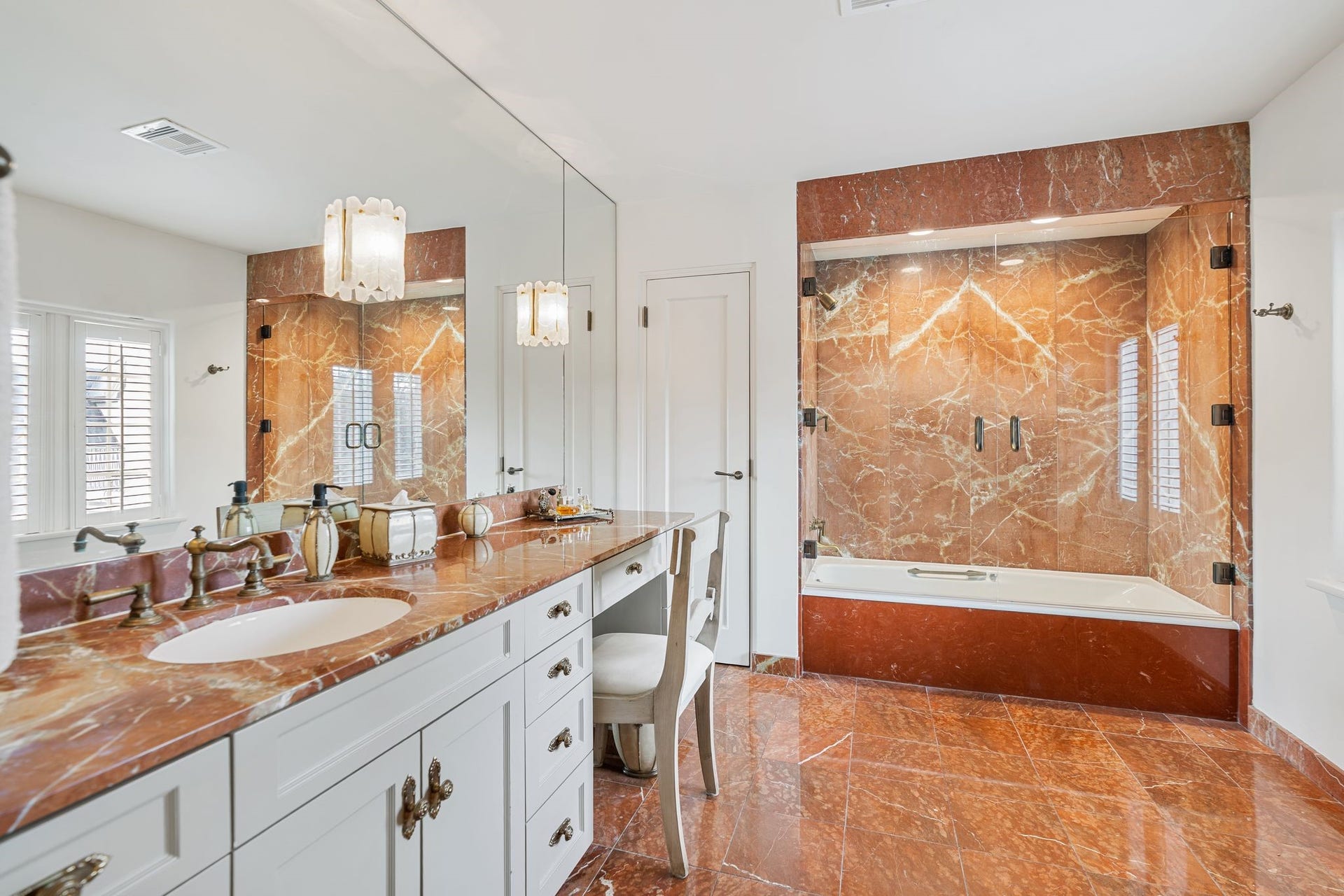 [En Suite Bath]
This rose marble-clad bath serves the previously shown bedroom and adjoining room. Note tub/shower with double glass doors.