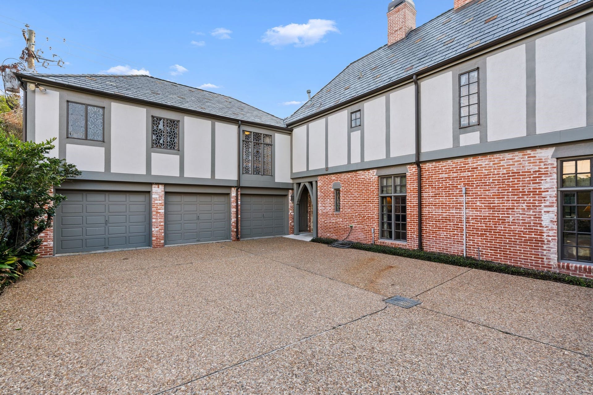 [Garage / Motor Court]
Doorway at right leads to the garage entrance and staircase to the apartment, the family room entrance, and the pavilion.
