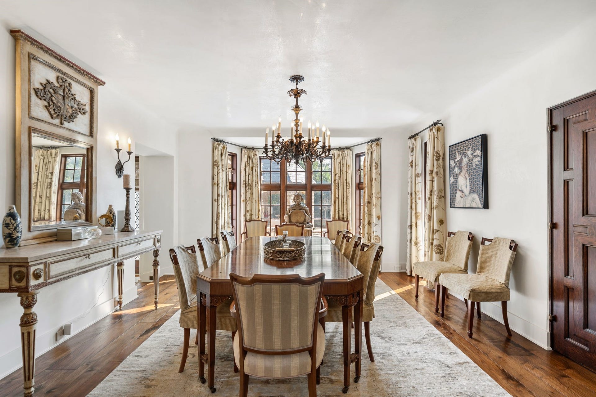 [Dining Room]
An open doorway from the foyer leads into the dining room, where magnificent, Chinese Export doors open to the living room (right). Bay windows at rear overlook the stone patio and pool