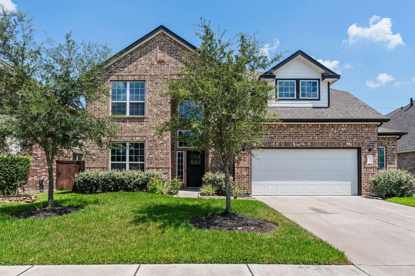 314 Arbor Ranch Circle, Richmond, TX 77469 Charming brick two-story with lush landscaping and inviting curb appeal