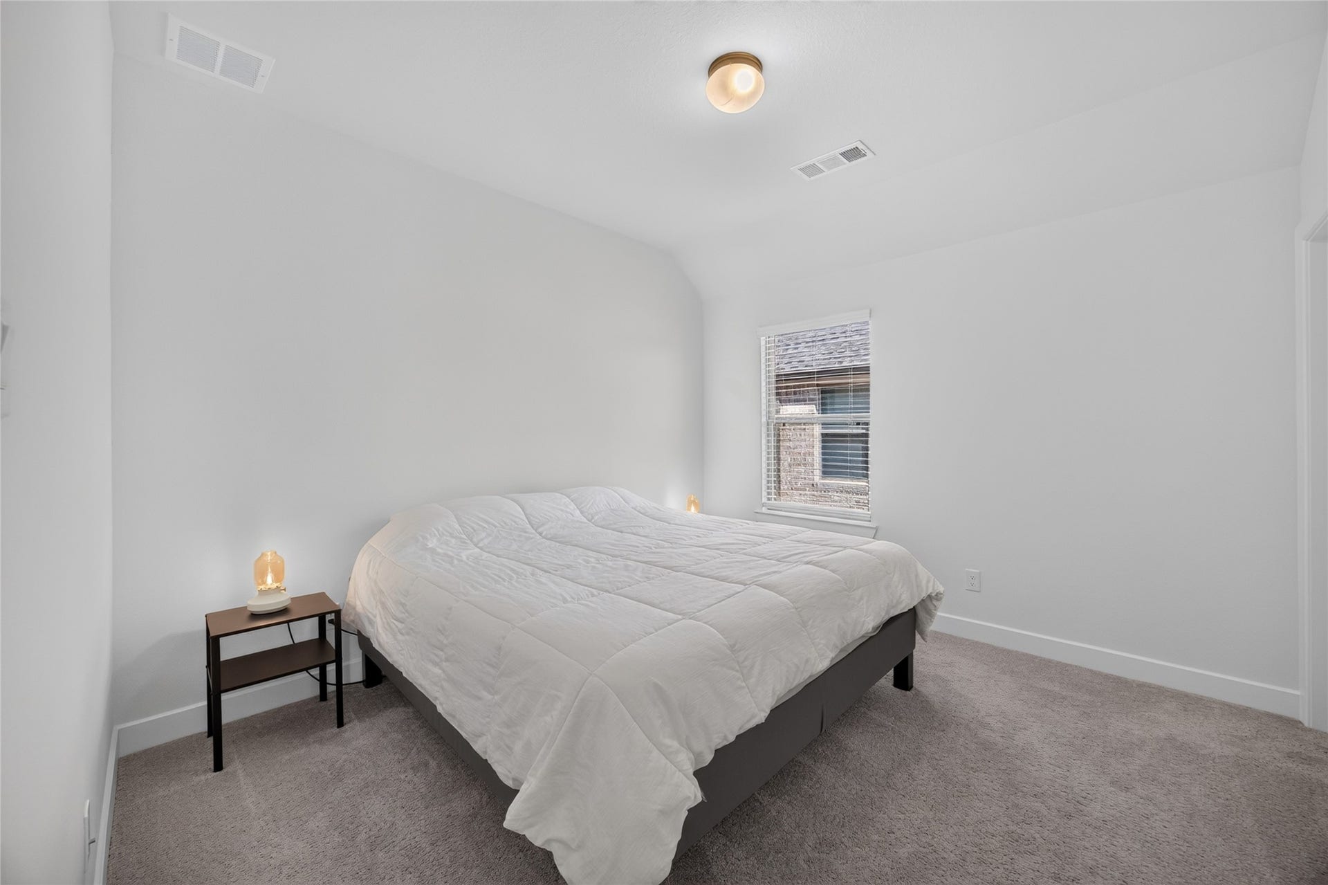 7311 Winding Aster Way, Katy, TX 77493 This upstairs secondary bedroom features neutral walls, carpeting and a window with blinds. The simple layout accommodates a bed, bedside furniture and additional storage pieces. Located away from the main gathering areas, the room provides a comfortable setting for sleeping, studying or hosting guests.