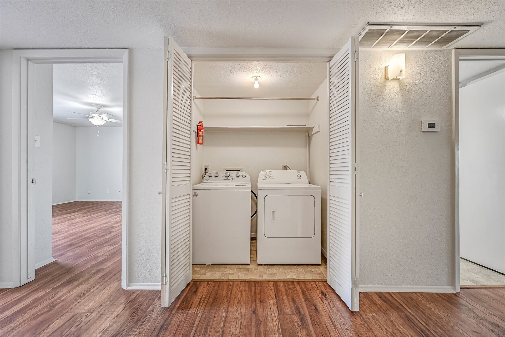5005 Georgi Lane, #155, Houston, TX 77092 A full-size washer & dryer are included with this condo, neatly tucked behind double louvered doors near the entry. Overhead shelving provides additional storage for laundry supplies, while the central location offers easy access from the bedrooms and main living areas. No shared laundry room needed!