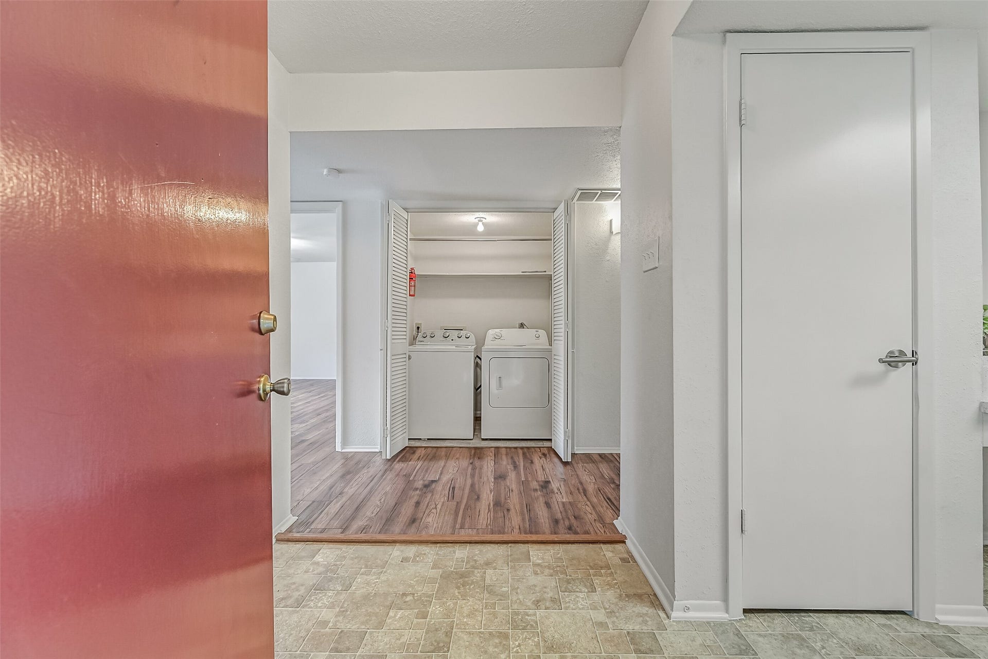 5005 Georgi Lane, #155, Houston, TX 77092 Just inside the front door, you'll find a dedicated laundry closet with a full-size washer & dryer included! Double louvered doors keep the appliances neatly tucked away, while shelving above provides additional storage. Wood-look flooring extends into the adjoining living areas.