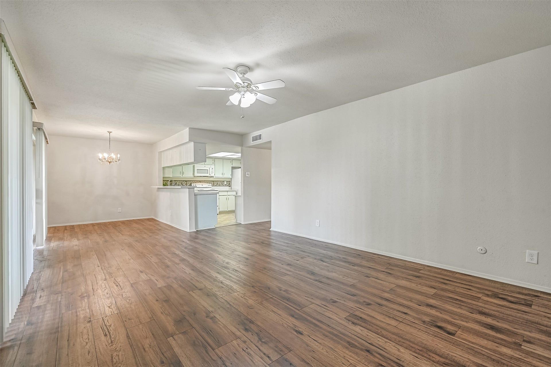 5005 Georgi Lane, #155, Houston, TX 77092 The generously sized living room offers plenty of flexibility for arranging your furniture, with attractive wood-look flooring, neutral walls & a lighted ceiling fan. An open layout connects the living room to the dining area & kitchen, creating an easy flow throughout the main living spaces.