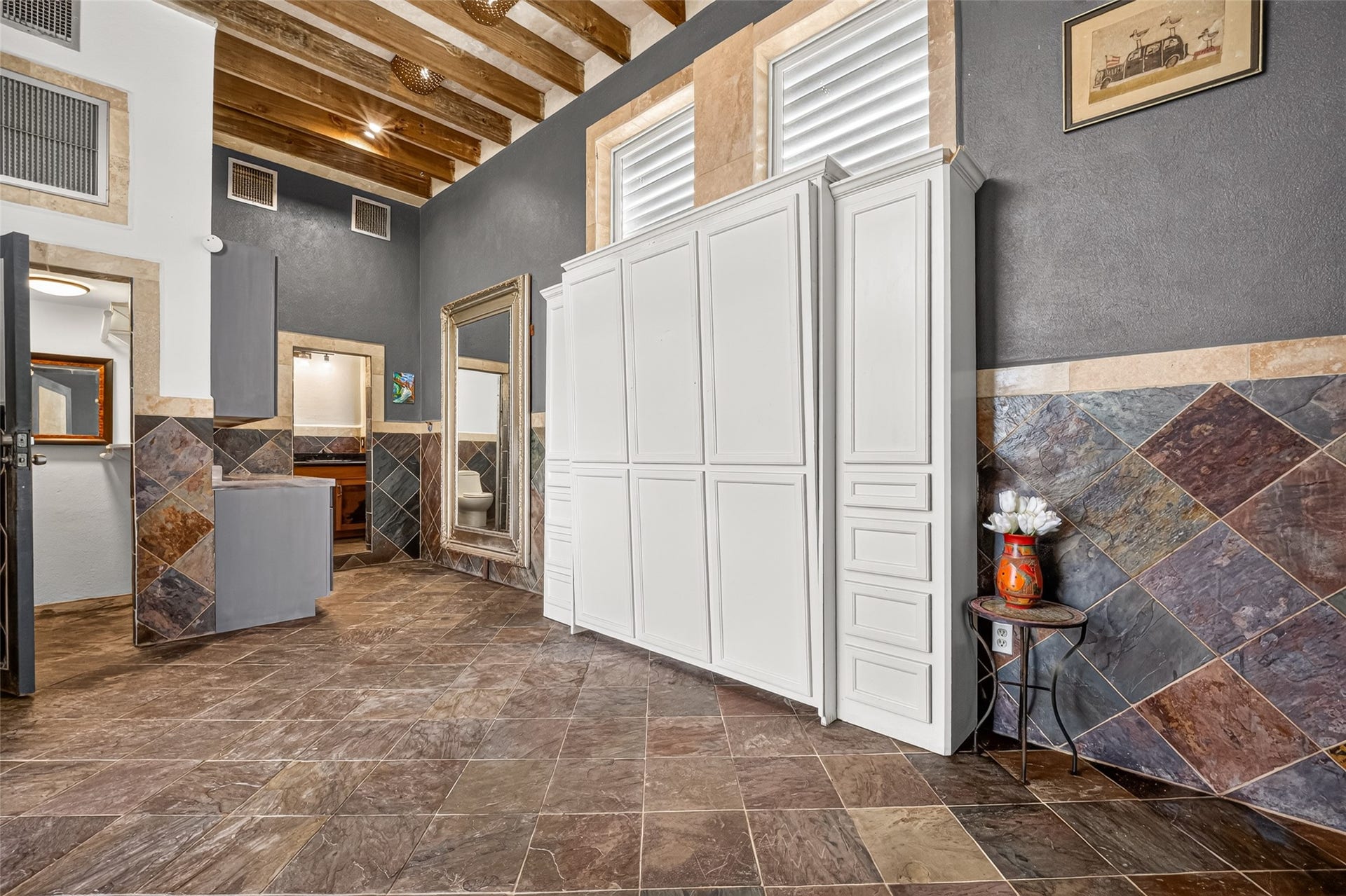 Tile floor and wall. Murphy Bed with side storage. Beamed ceiling. Unit designed for those who like simplicity.