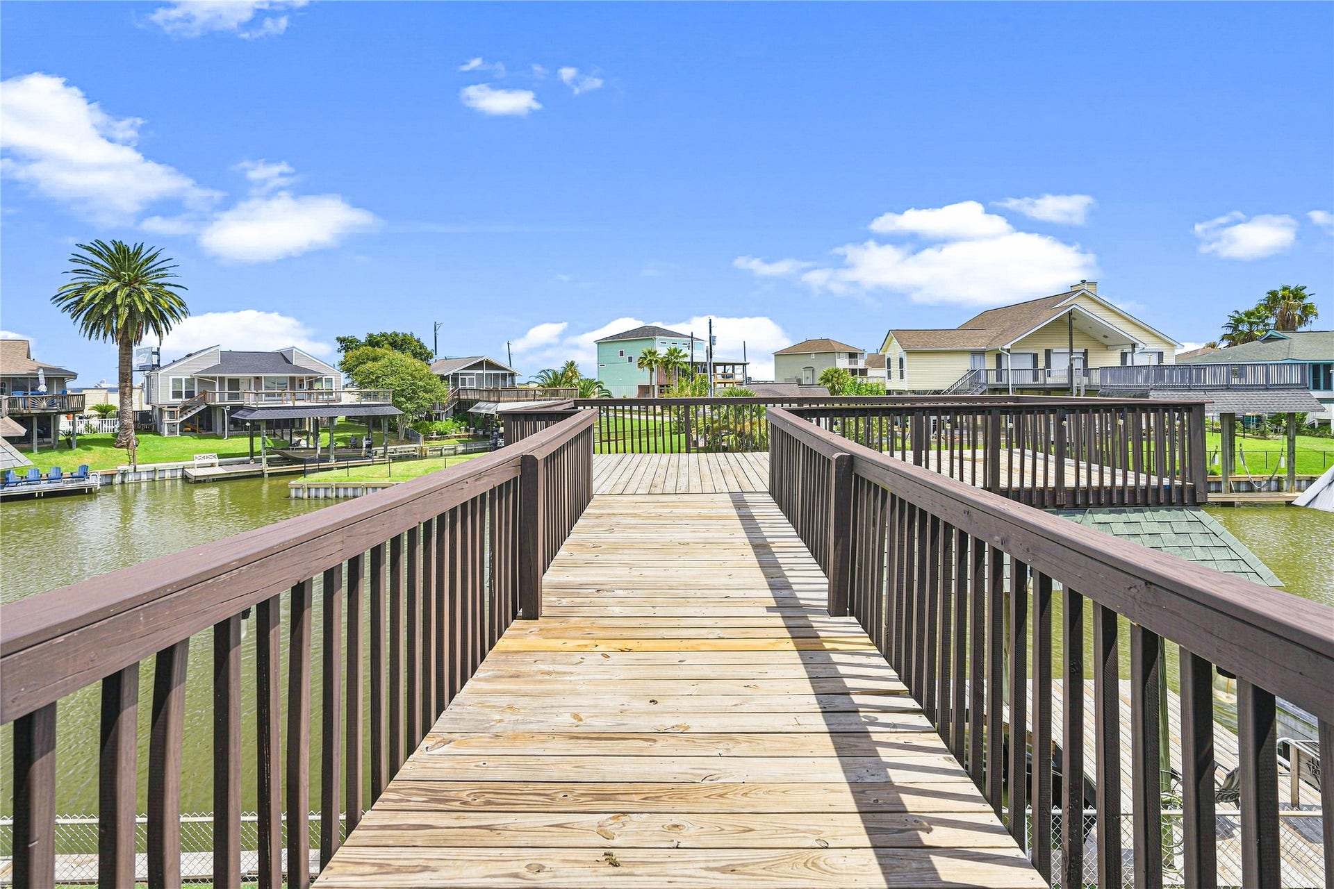 19 N Sandpiper Street, La Marque, TX 77568 Expansive waterfront deck provides stunning canal views, perfect for relaxation in serene surroundings.
