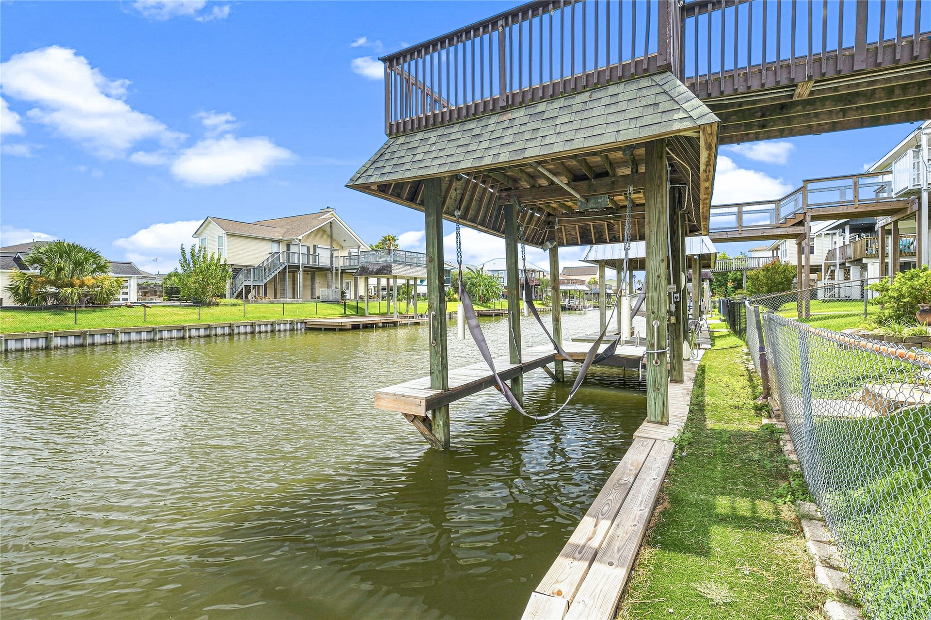 19 N Sandpiper Street, La Marque, TX 77568 Waterfront property with a private boat lift and dock, offering serene canal views and easy access for boating enthusiasts. Ideal for enjoying outdoor living and quick waterway adventures.