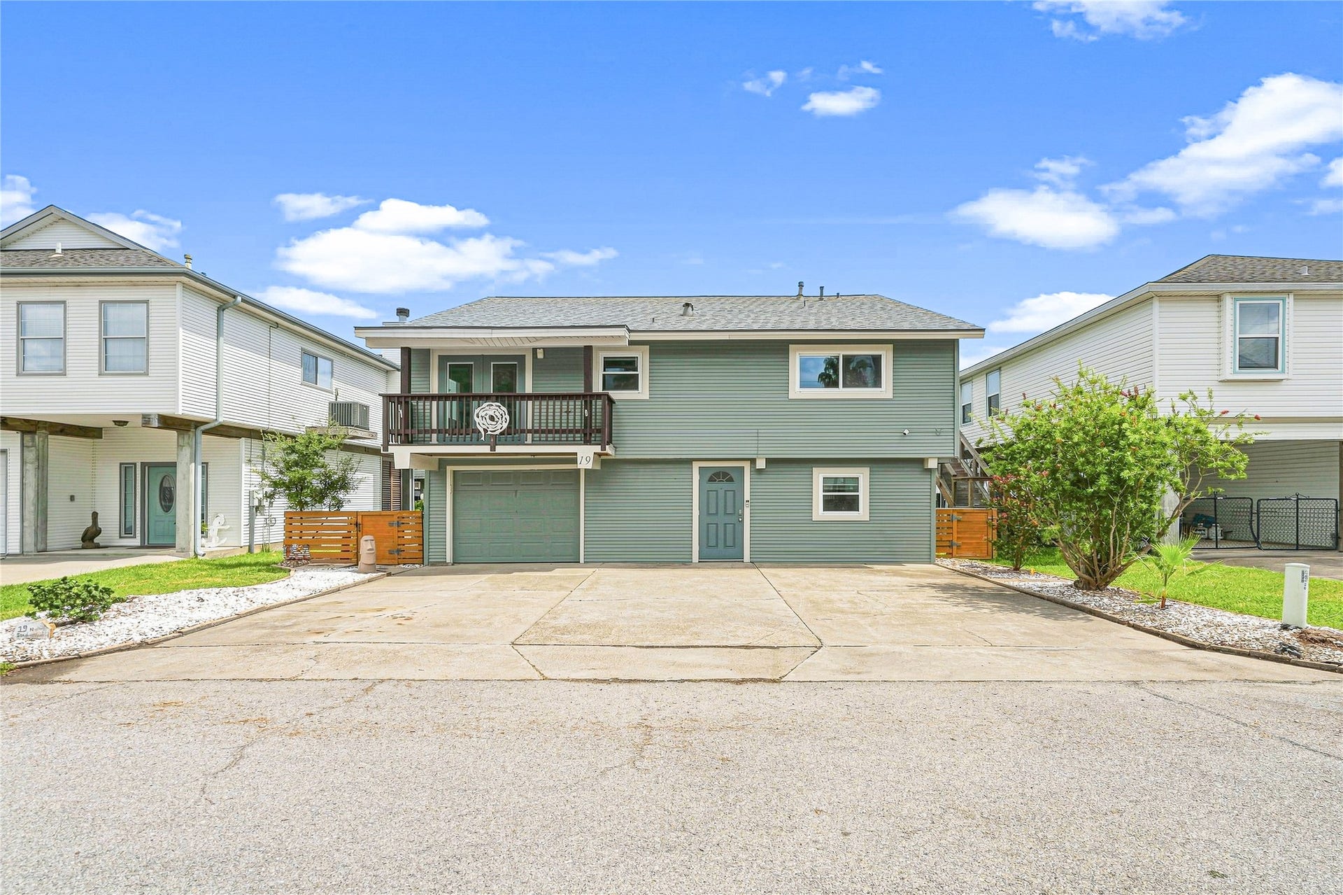 19 N Sandpiper Street, La Marque, TX 77568 Charming two-story home with a spacious driveway, inviting balcony, and well-maintained landscaping, nestled in a friendly neighborhood.
