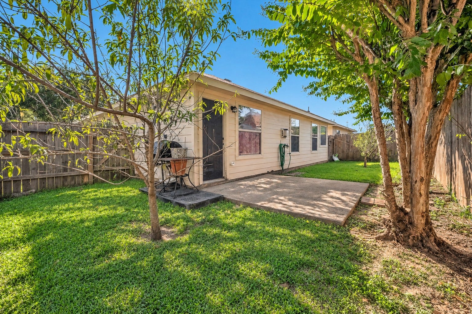 15835 Aldridge Creek Court, Cypress, TX 77429 Enjoy a private, fully fenced backyard with mature shade trees and a concrete patio perfect for outdoor relaxation.