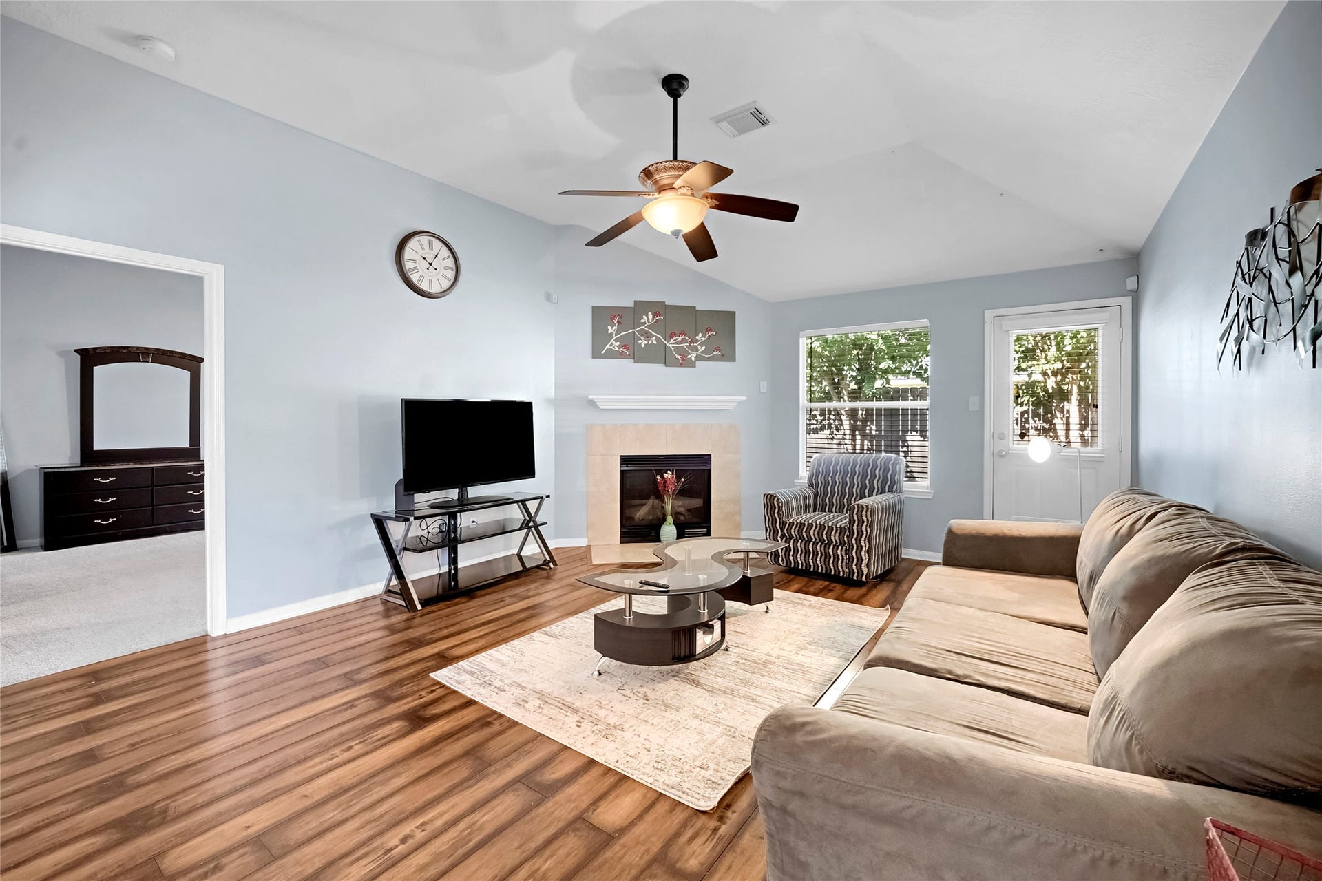 15835 Aldridge Creek Court, Cypress, TX 77429 Another view of the furnished family room featuring a fireplace and backyard access.