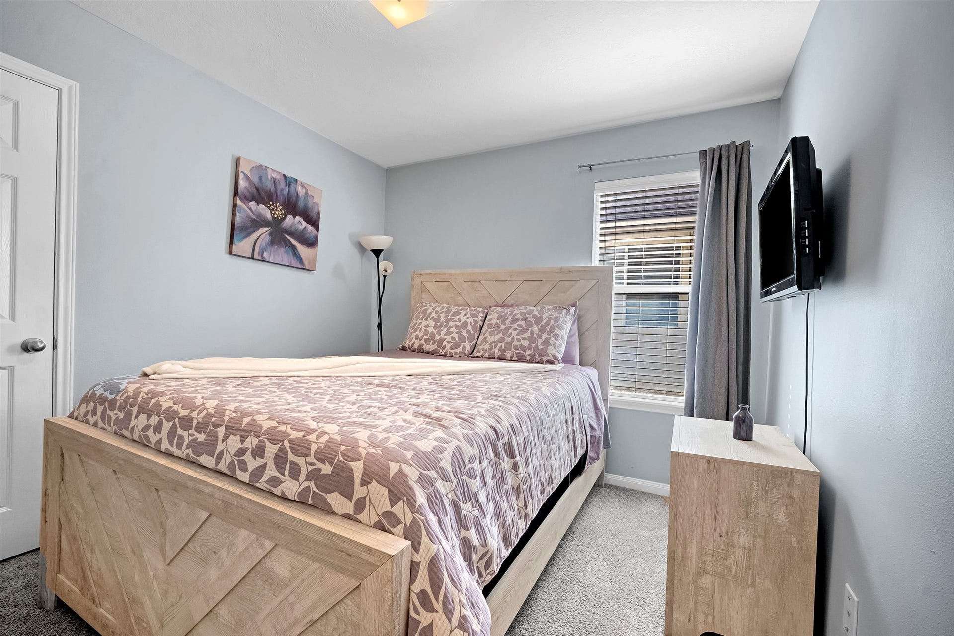 15835 Aldridge Creek Court, Cypress, TX 77429 Furnished secondary bedroom with bed, dresser, and wall-mounted television.