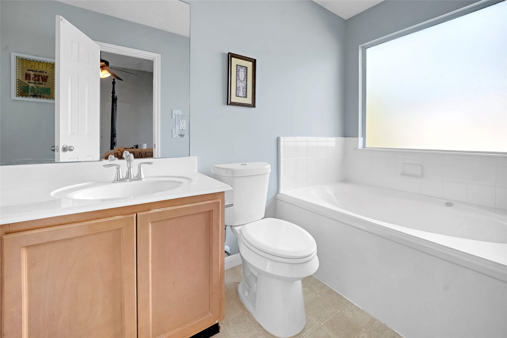 15835 Aldridge Creek Court, Cypress, TX 77429 Primary bathroom featuring a soaking tub, natural light, and vanity.