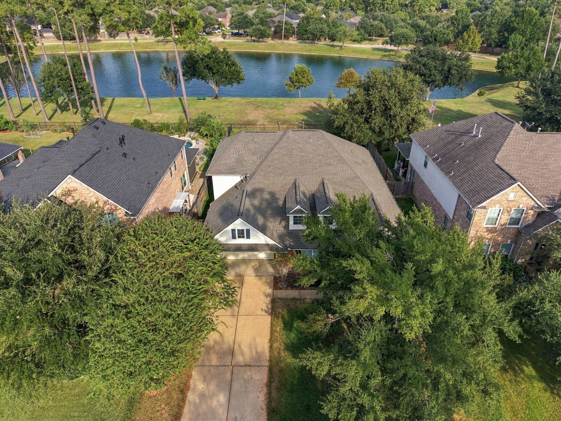 14226 Marin Drive, Cypress, TX 77429 Highlighting exceptional neighborhood positioning, this bird's-eye perspective reveals an expansive lot nestled along a scenic waterfront backdrop.
