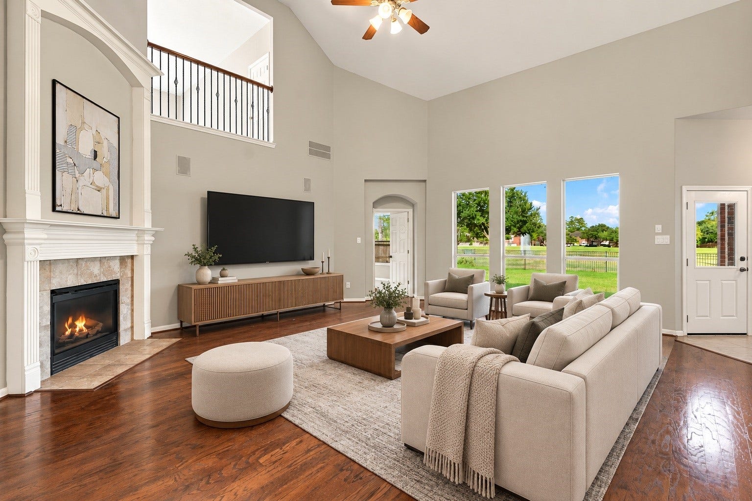 14226 Marin Drive, Cypress, TX 77429 Virtually Staged: Designed with impressive proportions, this expansive family room offers exceptional vertical space and a seamless flow. Key features include a focal fireplace, overhead ceiling fan, and high-set wall windows that capture scenic outdoor views.