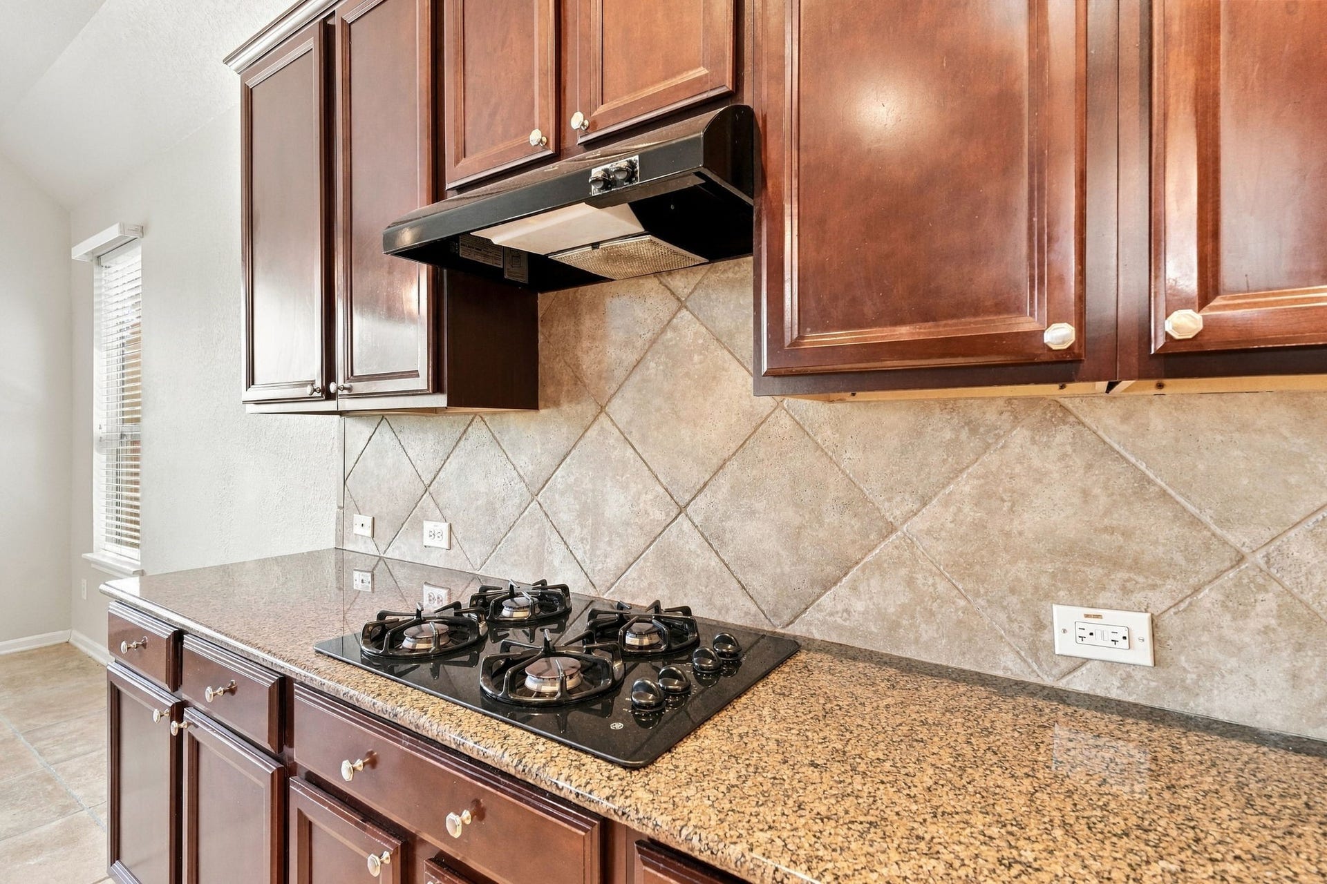 14226 Marin Drive, Cypress, TX 77429 Highlighting quality craftsmanship, this prep zone combines rich wooden cabinetry with seamless granite counters.