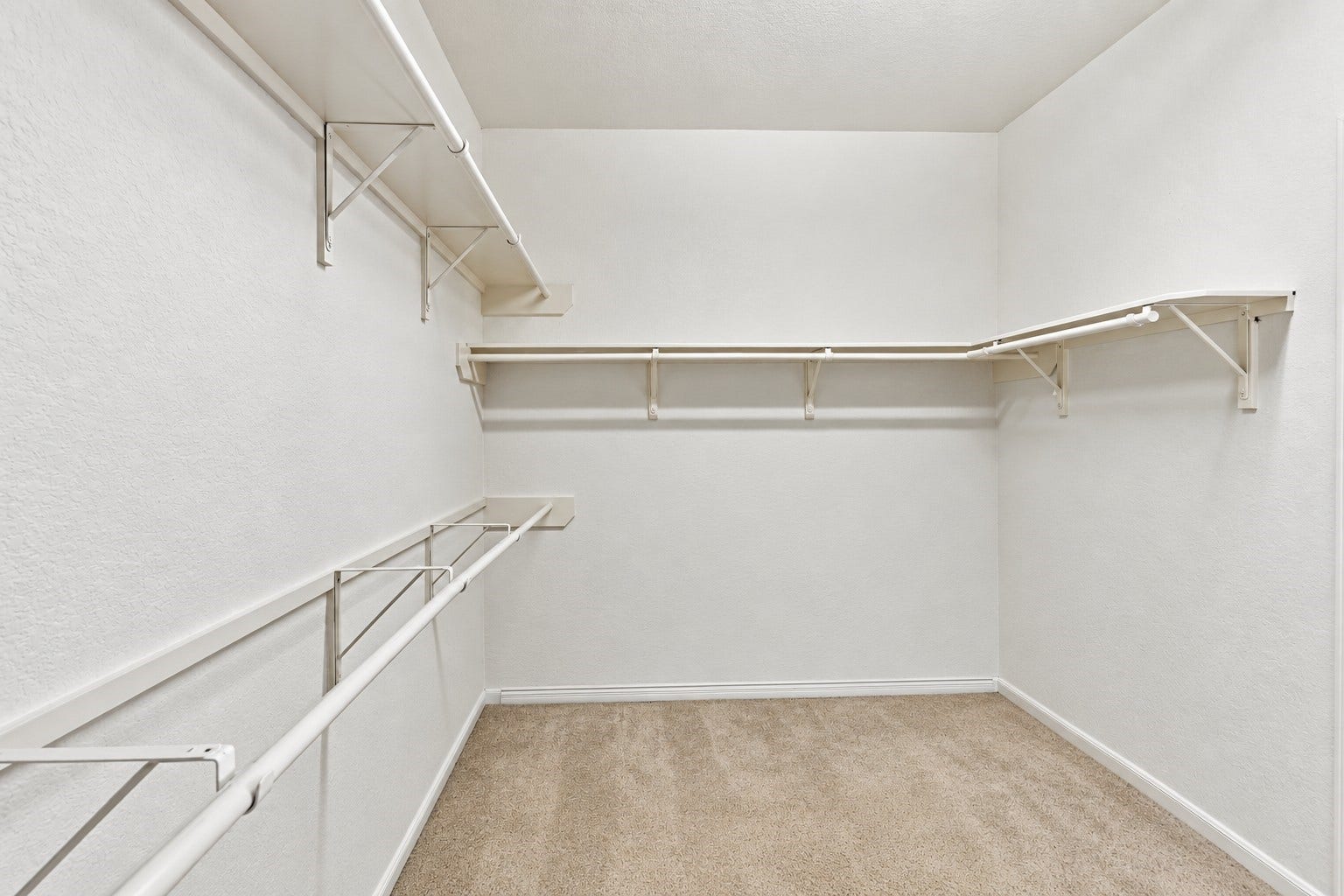 14226 Marin Drive, Cypress, TX 77429 A spacious walk-in primary closet offering generous storage and organization space. Multiple hanging rods and built-in shelving extend along several walls, providing plenty of room for clothing, shoes, and accessories.