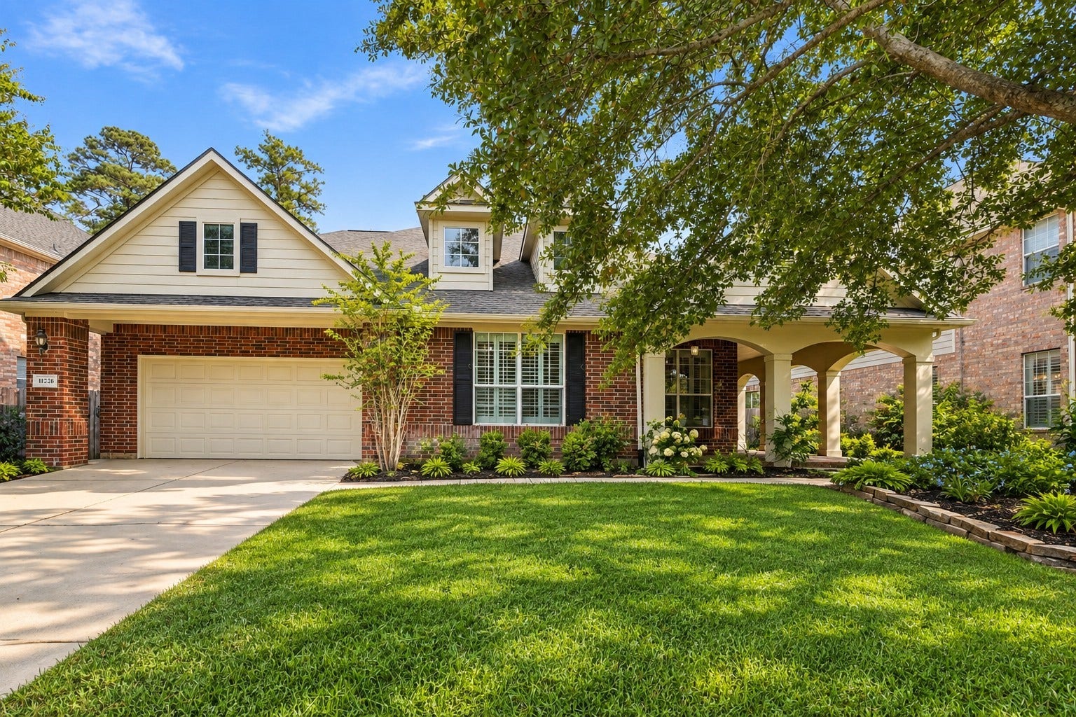 14226 Marin Drive, Cypress, TX 77429 Practical features like a large driveway and generous garage space are paired with a cozy covered porch nestled among mature, leafy trees and vibrant gardens.