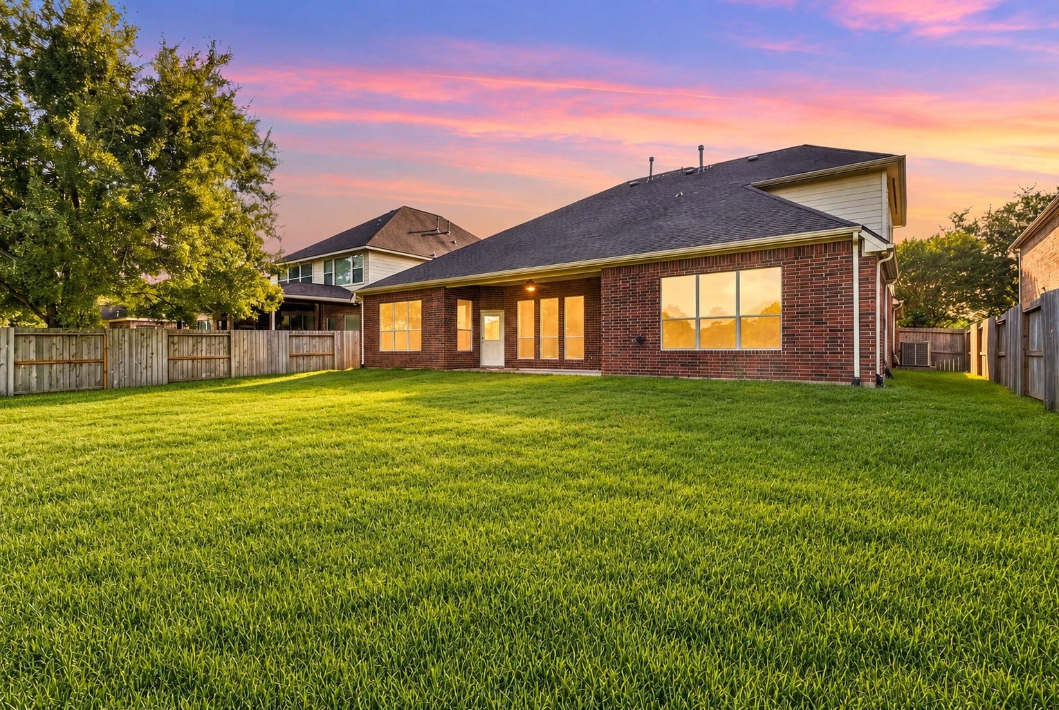 14226 Marin Drive, Cypress, TX 77429 Featuring an impressive lot size with a secure wooden perimeter fence, this property delivers a broad expanse of lush green turf.