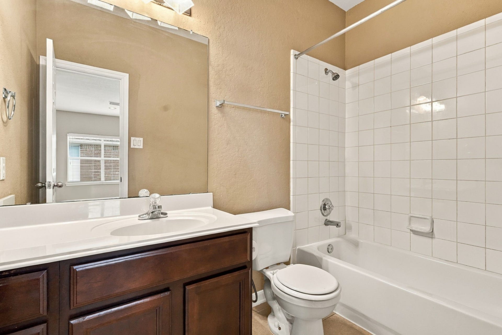 14226 Marin Drive, Cypress, TX 77429 Offering a practical full-bath setup, this space incorporates a single sink vanity with lower storage, bright vanity overhead lighting, and a full-size soaking tub with shower fixtures.