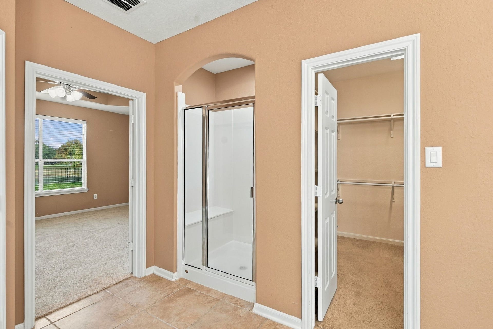 14226 Marin Drive, Cypress, TX 77429 Designed for everyday convenience, this primary bathroom layout features a separate glass walk-in shower stall with integrated seating and easy-care tile flooring.