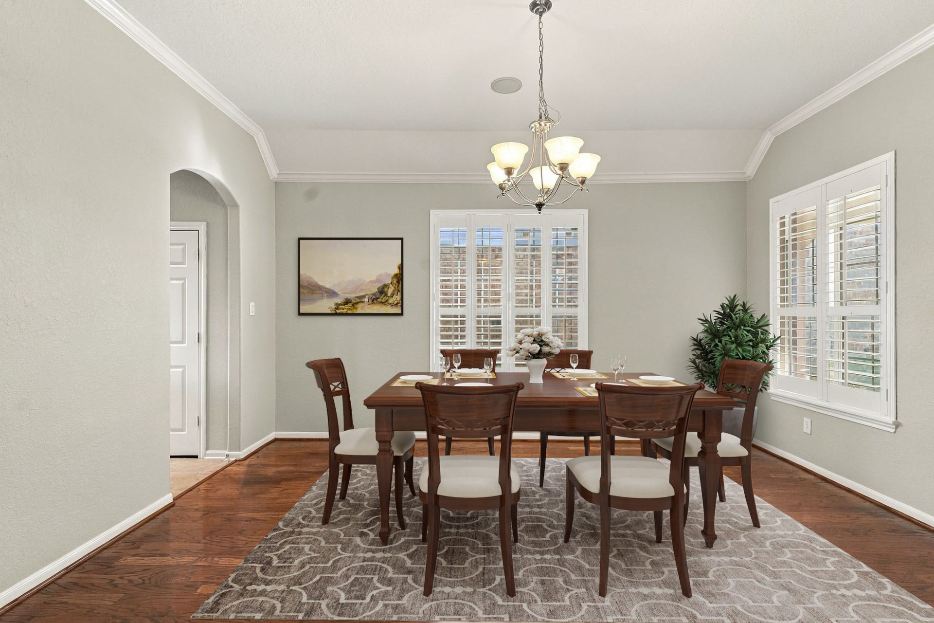 14226 Marin Drive, Cypress, TX 77429 Virtually Staged: This elegant formal dining room features tray ceiling detailing, refined crown molding, and a traditional chandelier centered over the space.