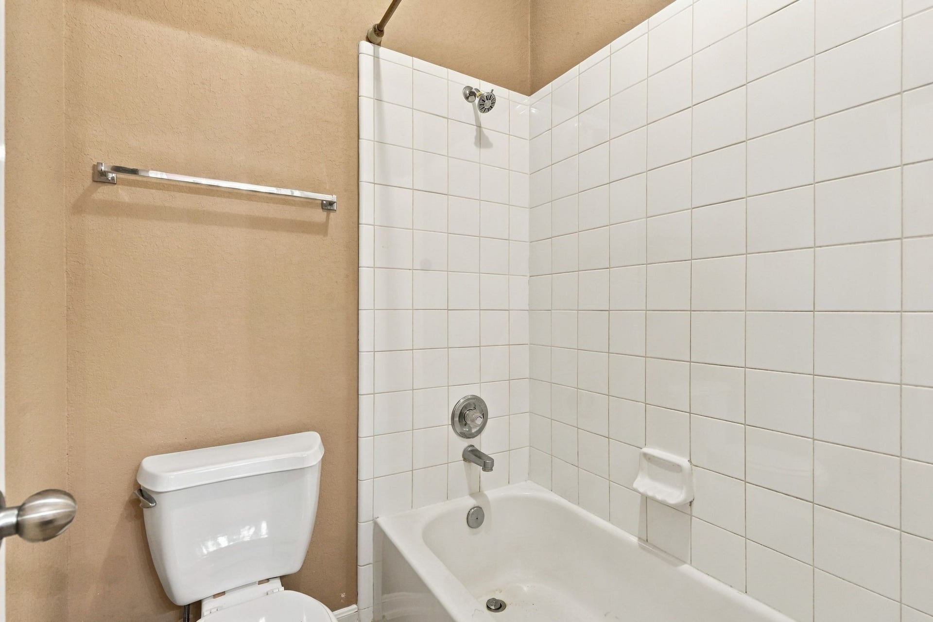 14226 Marin Drive, Cypress, TX 77429 A functional full bathroom featuring a tub-and-shower combination with white tile surround, and chrome fixtures.