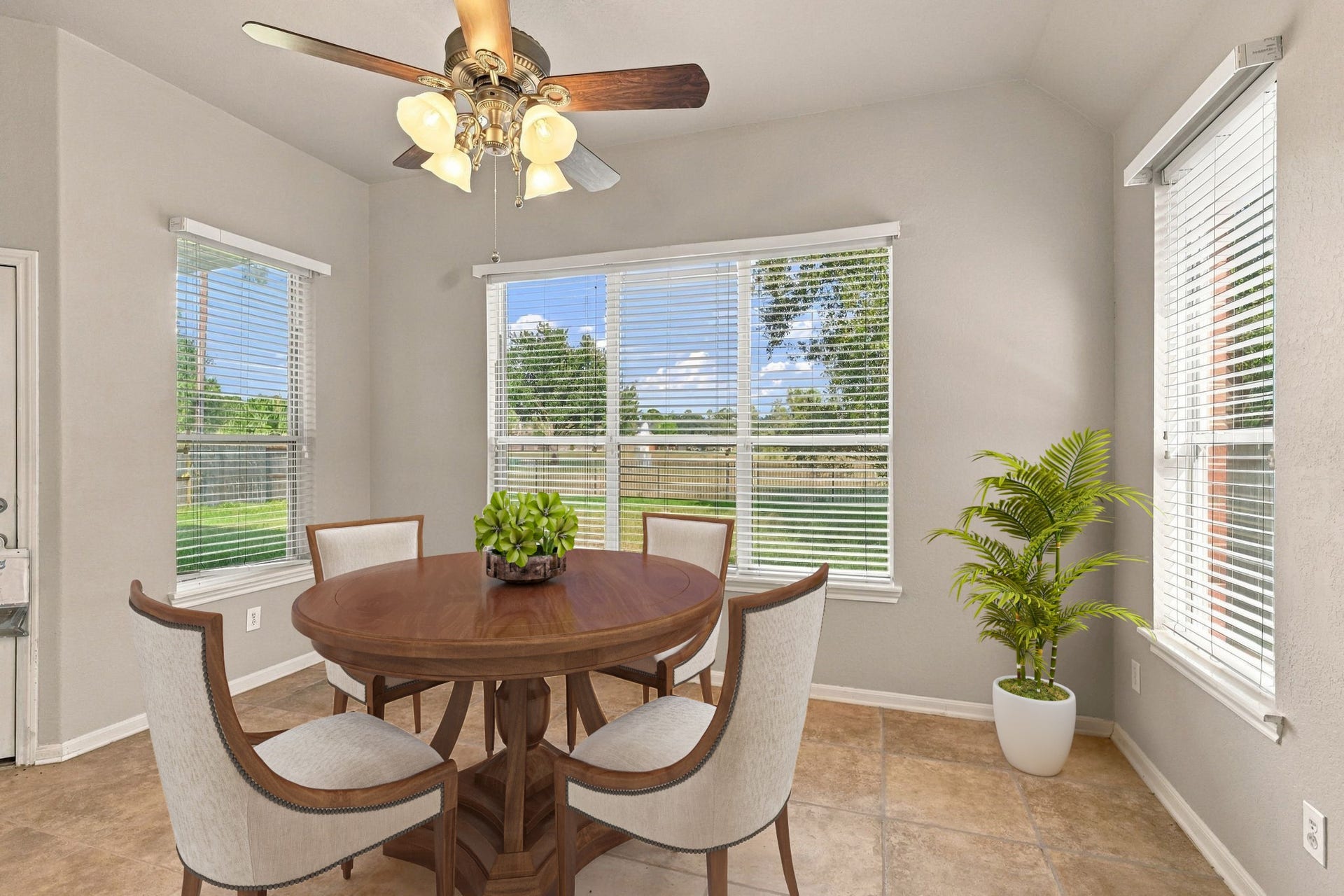 14226 Marin Drive, Cypress, TX 77429 Virtually Staged: This sun-drenched breakfast nook features expansive windows that capture picturesque backyard views while bathing the area in natural light.