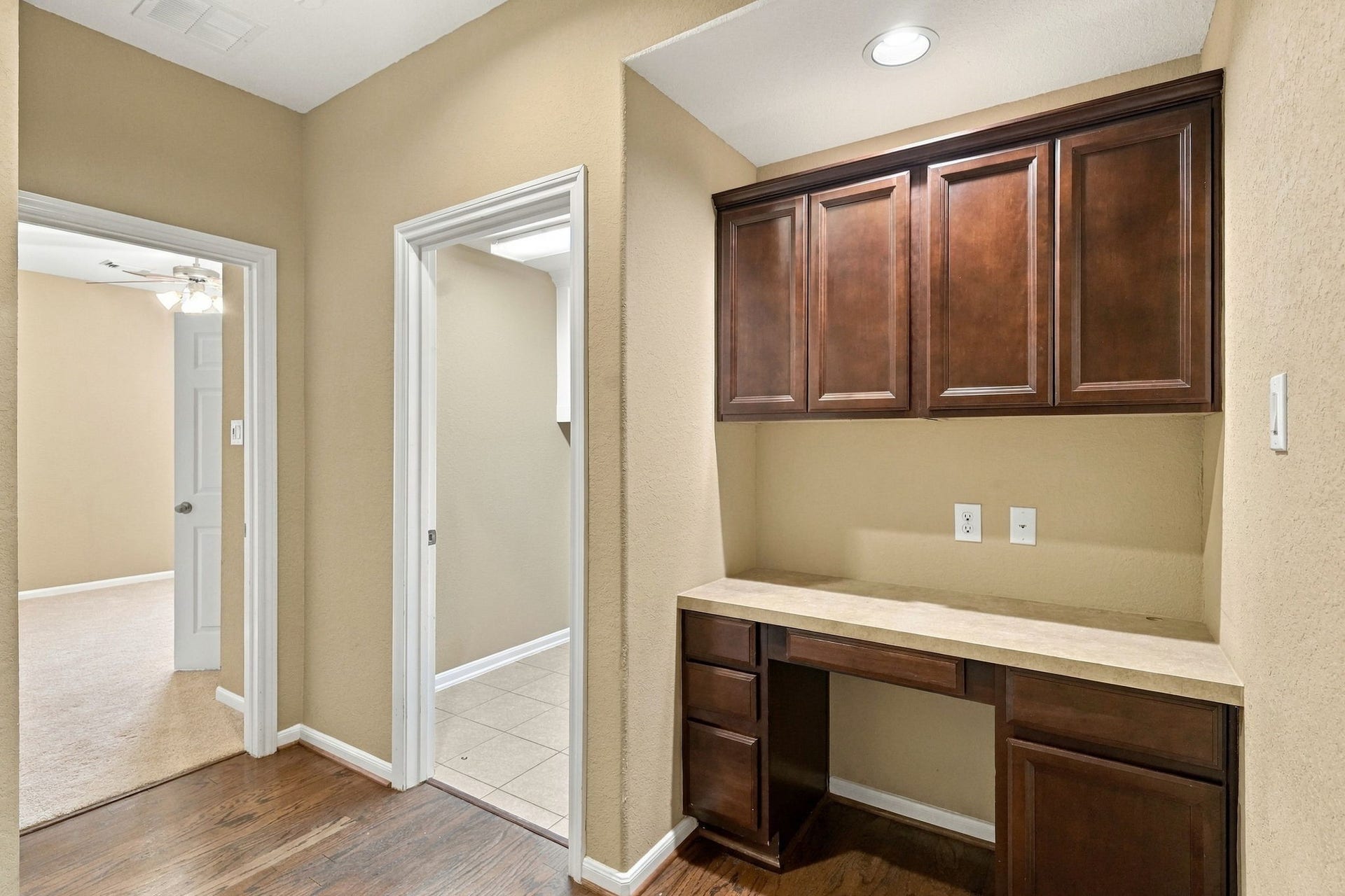 14226 Marin Drive, Cypress, TX 77429 This versatile built-in desk alcove features custom upper cabinetry, lower storage drawers, and an expansive workspace.