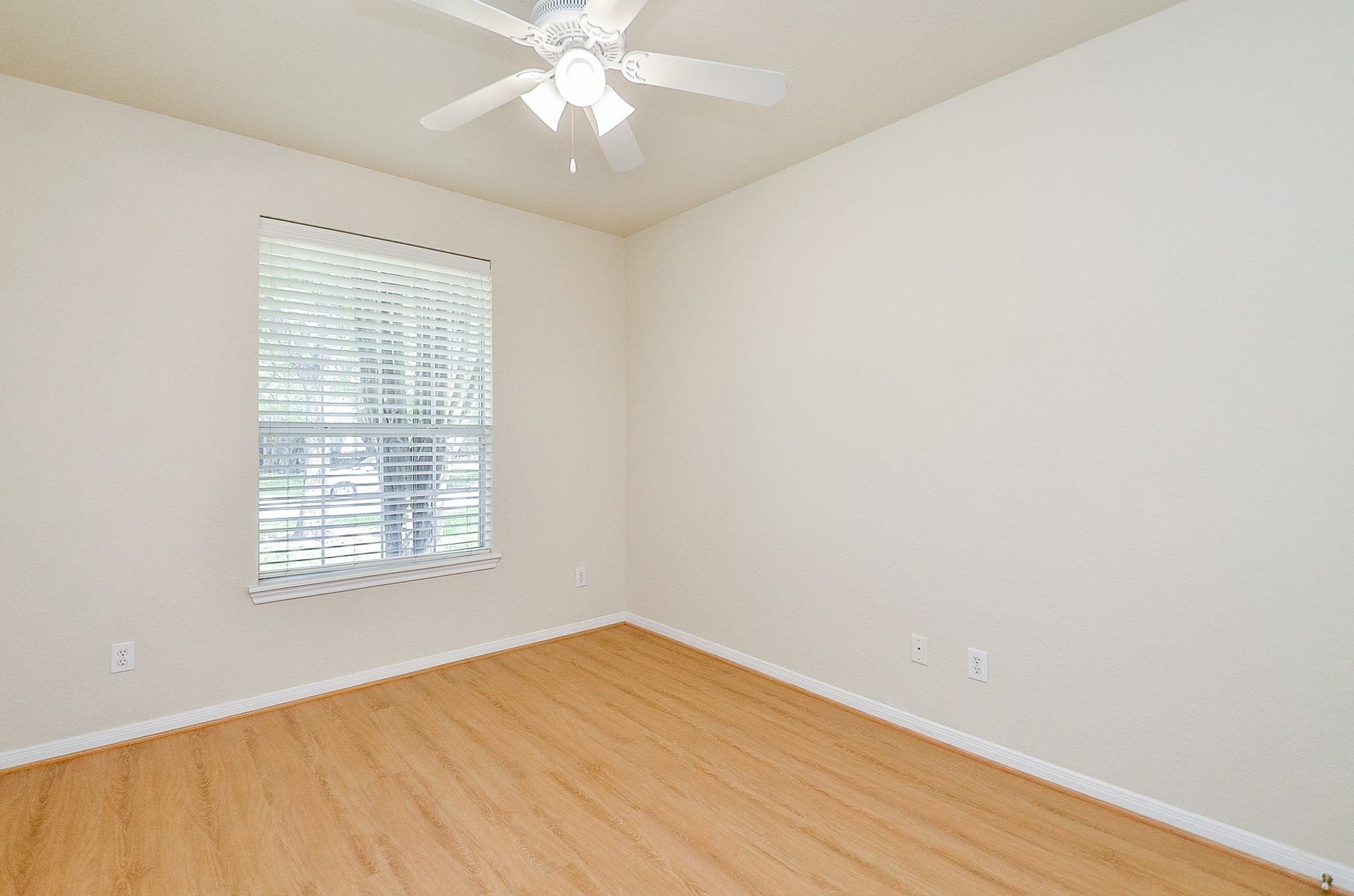 14407 Spanish River Lane, Cypress, TX 77429 Comfortable room sizes continue beyond the primary suite. This downstairs bedroom offers plenty of space for a full bedroom setup, with new paint and easy-care flooring providing a fresh start.