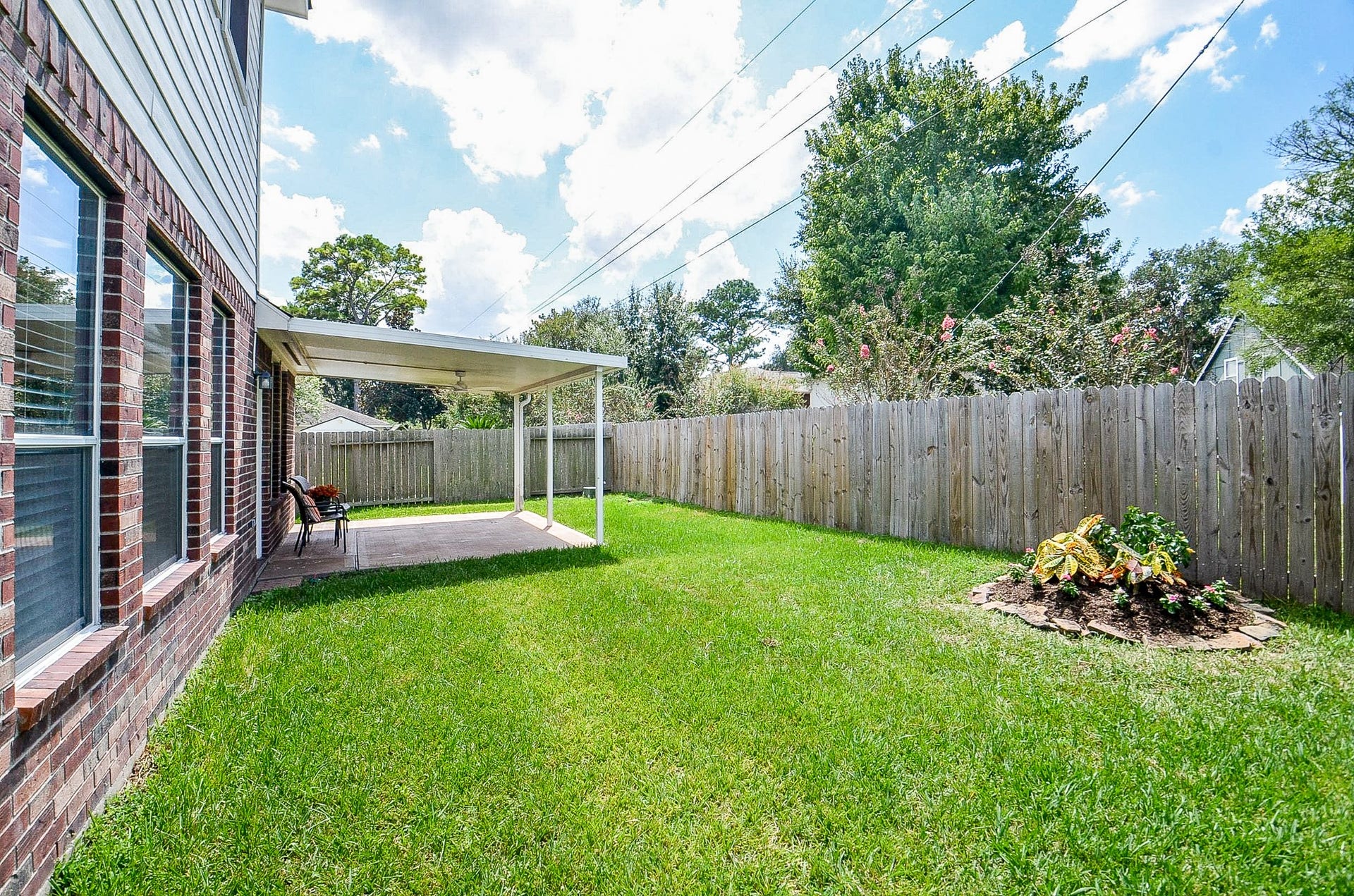 14407 Spanish River Lane, Cypress, TX 77429 The open lawn offers space for a playset, garden, games with the kids or four-legged family members, while the covered patio gives everyone a shaded place to gather.