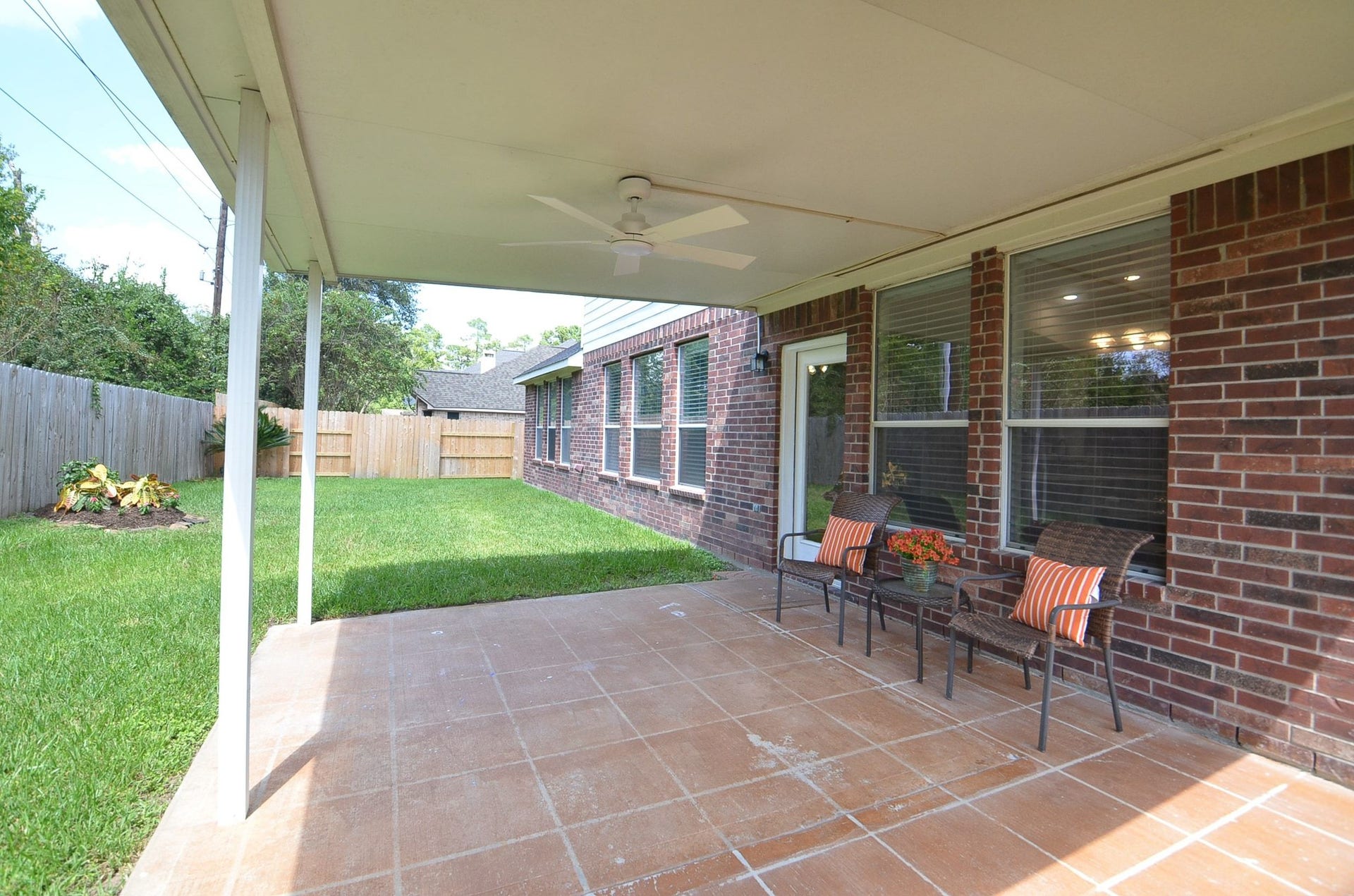 14407 Spanish River Lane, Cypress, TX 77429 This is where the backyard becomes part of everyday living. The generously sized covered patio offers plenty of room for outdoor seating and dining, with a ceiling fan overhead to make relaxing outside even more enjoyable.
