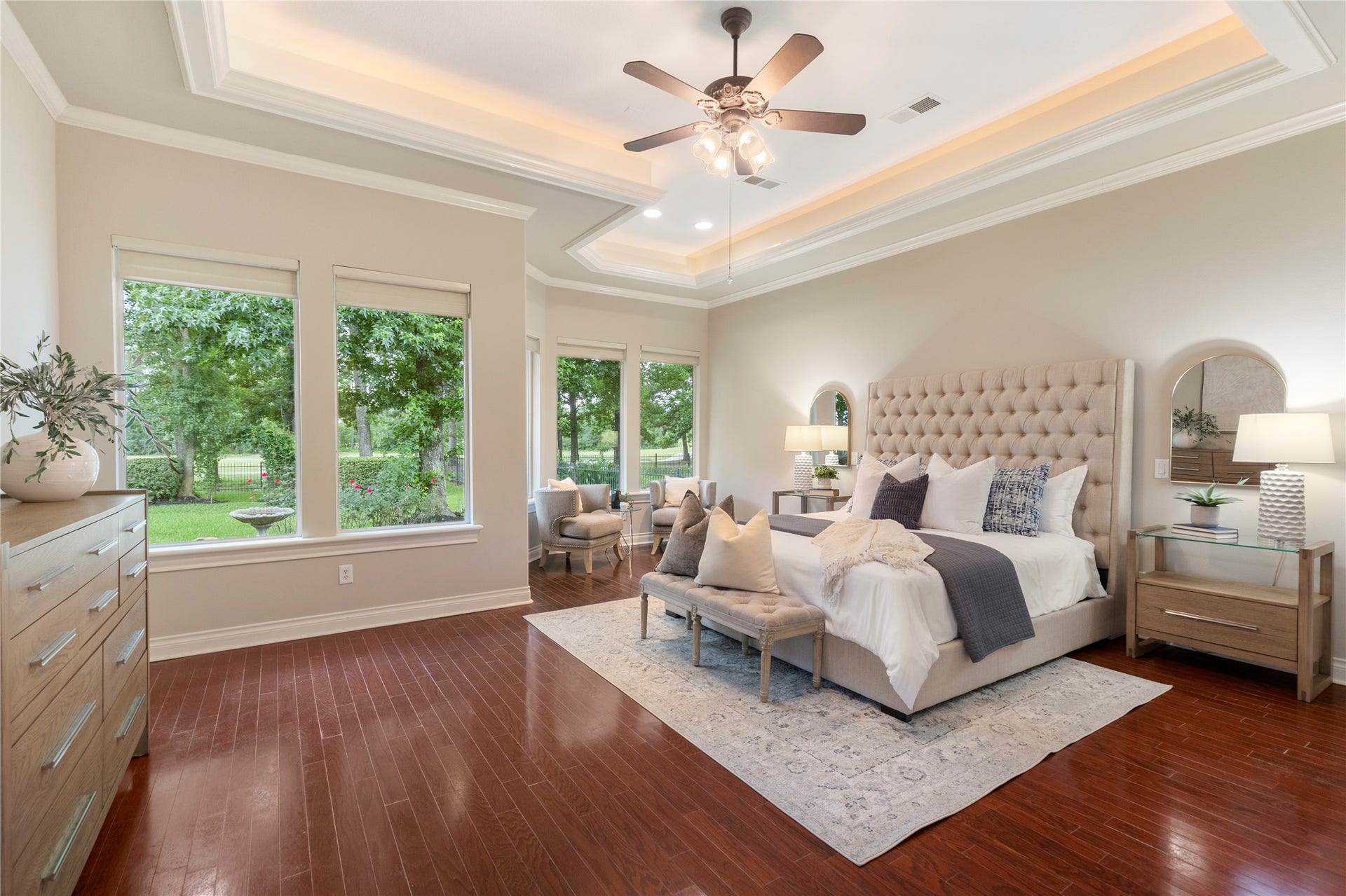 6207 Windrose Hollow Lane, Spring, TX 77379 The first floor primary suite feels private and serene, positioned at the back of the home for quiet separation. Wood flooring and backyard views create a restful retreat with an elevated feel.