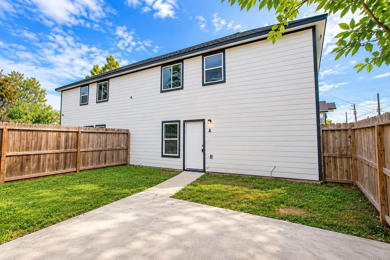 8204 Eastover Street, #A, Houston, TX 77028 Private fenced backyard with a walkway to the back door.