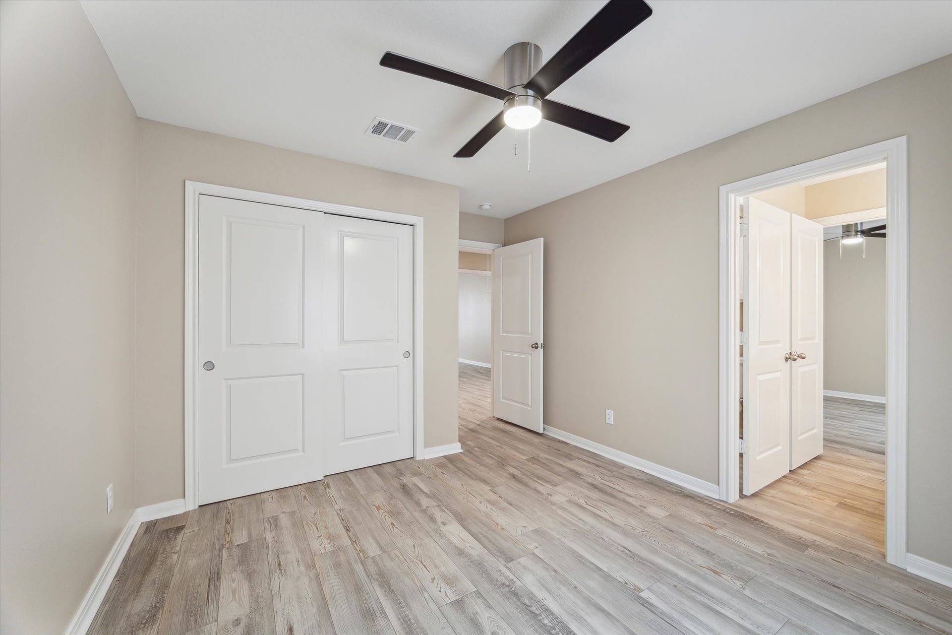 This the one of the secondary bed rooms.  The door to the right leads into the second bath to share with the other bed room.  The double doors to the left is the closet.