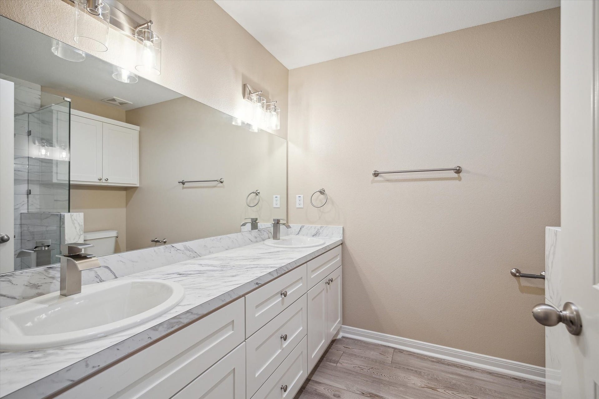 This is the Primary bath room with double sinks and a large glass shower.