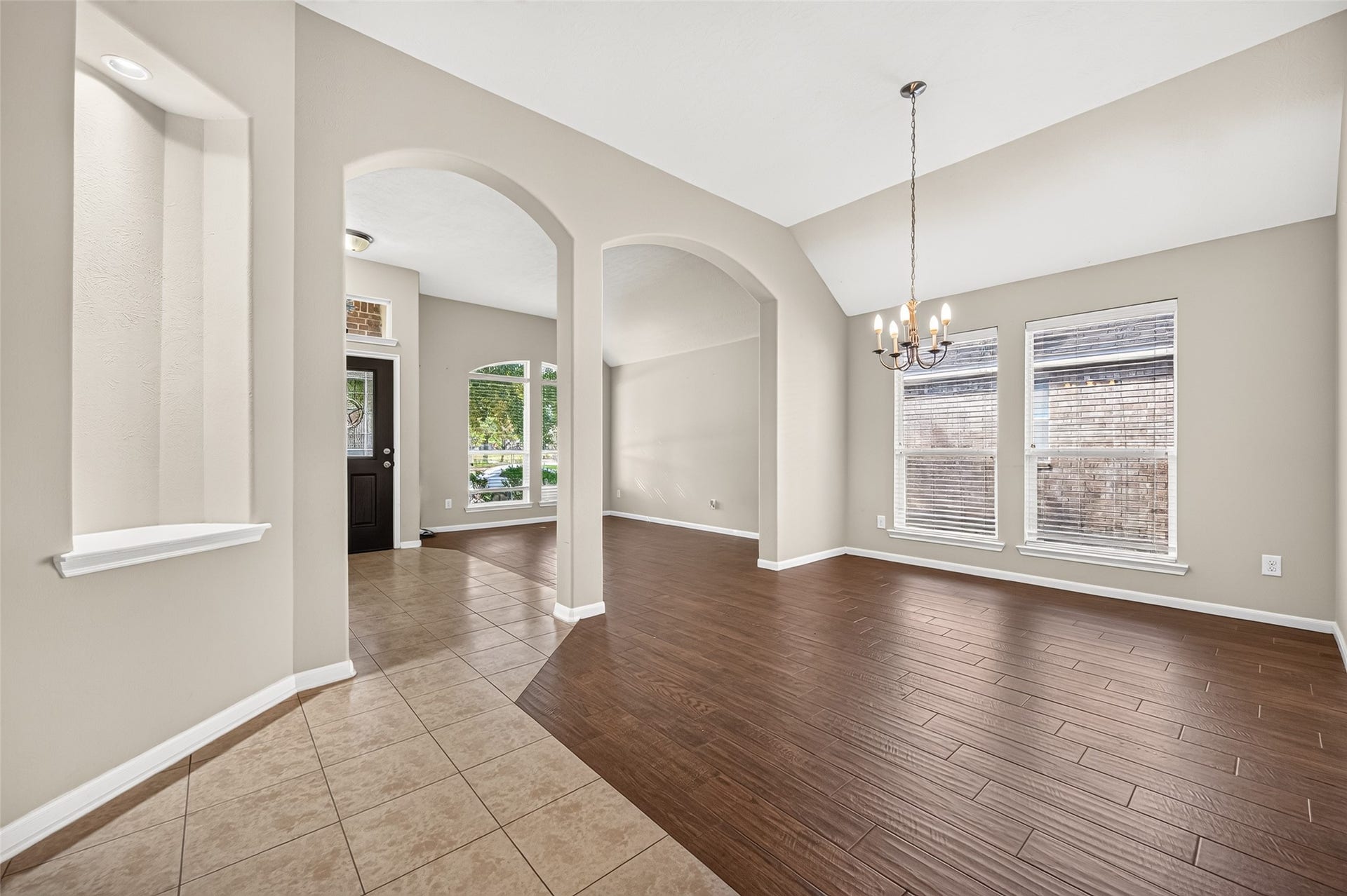 9307 Russeff Field Lane, Rosenberg, TX 77469 Bright entryway featuring arched openings, neutral walls, and a combination of tile and wood-look flooring.