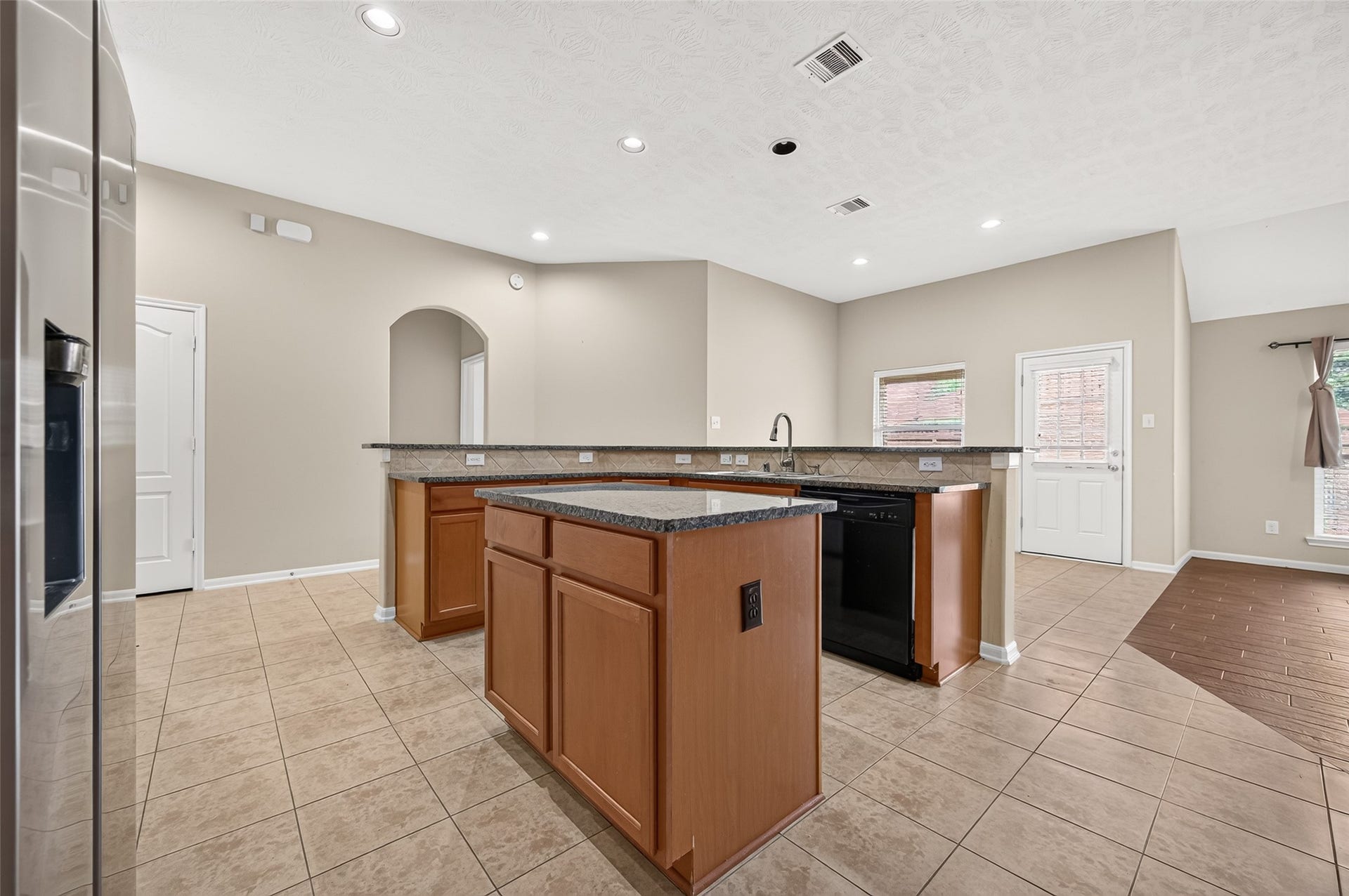 9307 Russeff Field Lane, Rosenberg, TX 77469 Additional kitchen view highlighting the center island, extensive cabinetry, and adjoining dining area.