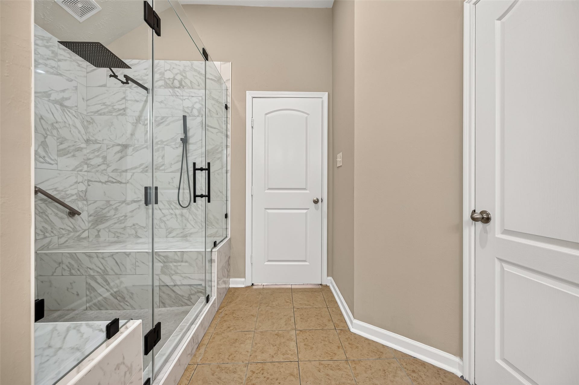 9307 Russeff Field Lane, Rosenberg, TX 77469 Walk-in shower featuring decorative tilework, a glass enclosure, and built-in shelving.