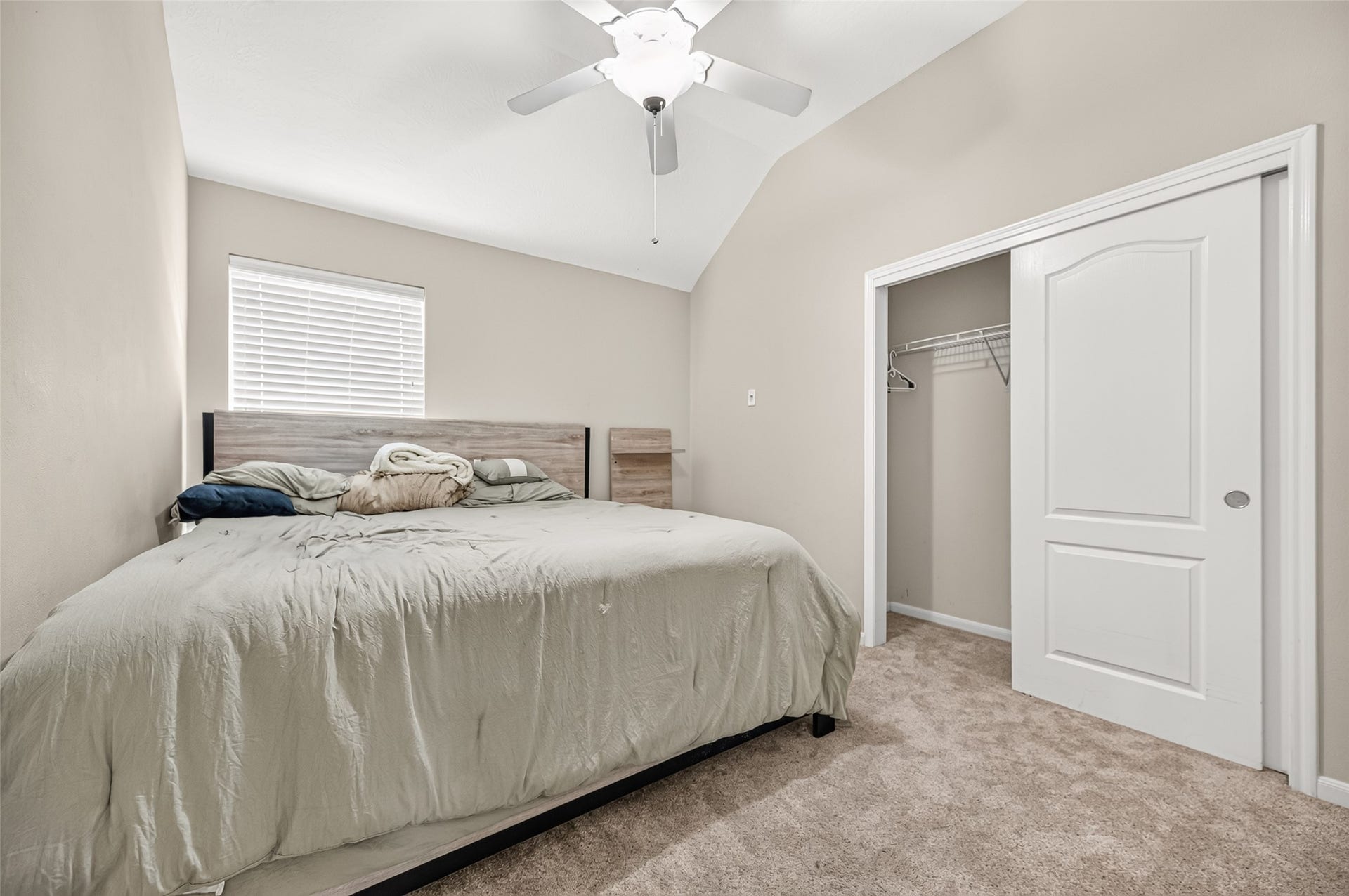 9307 Russeff Field Lane, Rosenberg, TX 77469 Secondary bedroom featuring neutral carpeting, ceiling fan, and a window overlooking the exterior.