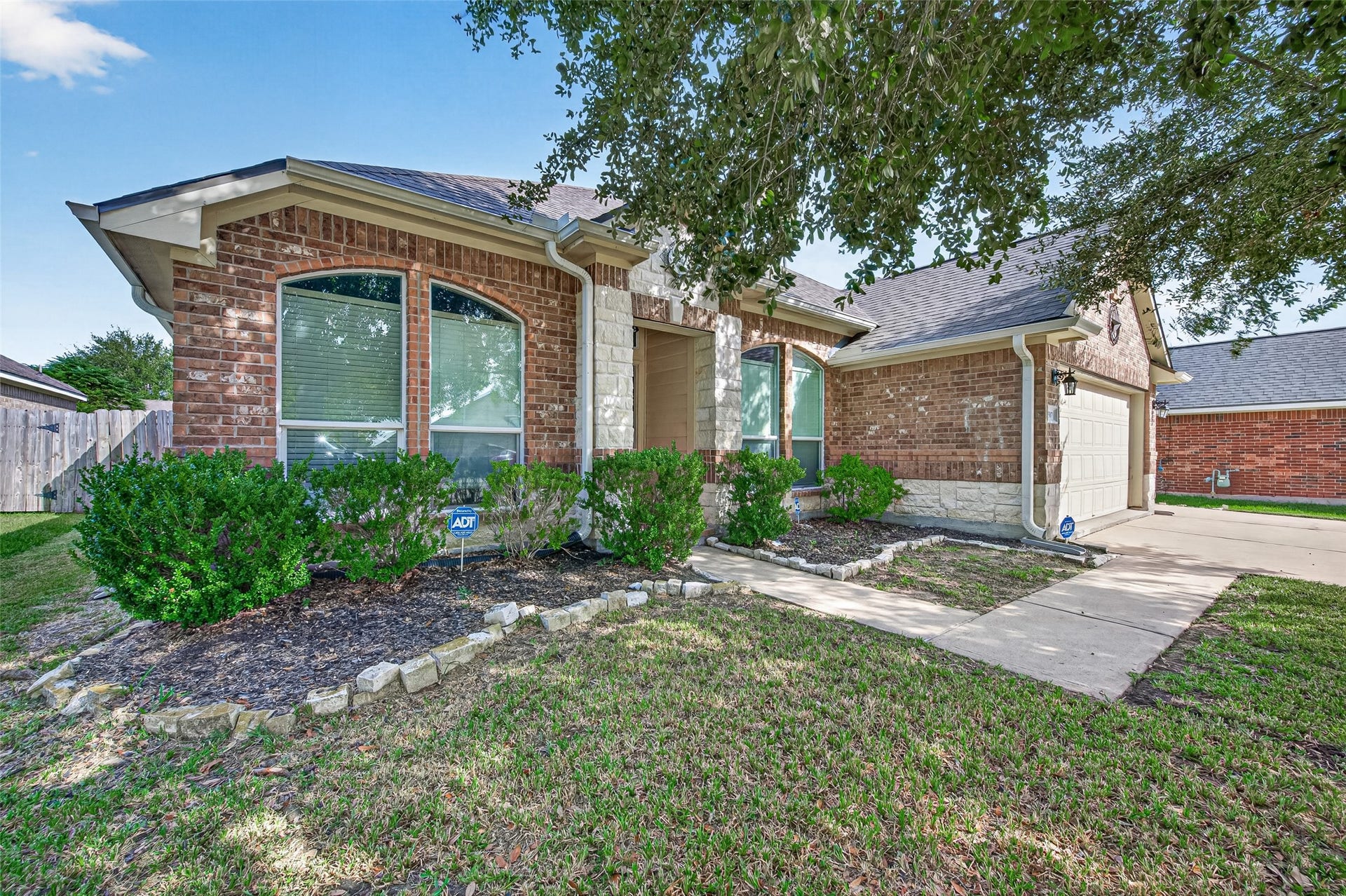 9307 Russeff Field Lane, Rosenberg, TX 77469 Additional backyard perspective highlighting the mature tree, fenced perimeter, and open lawn.