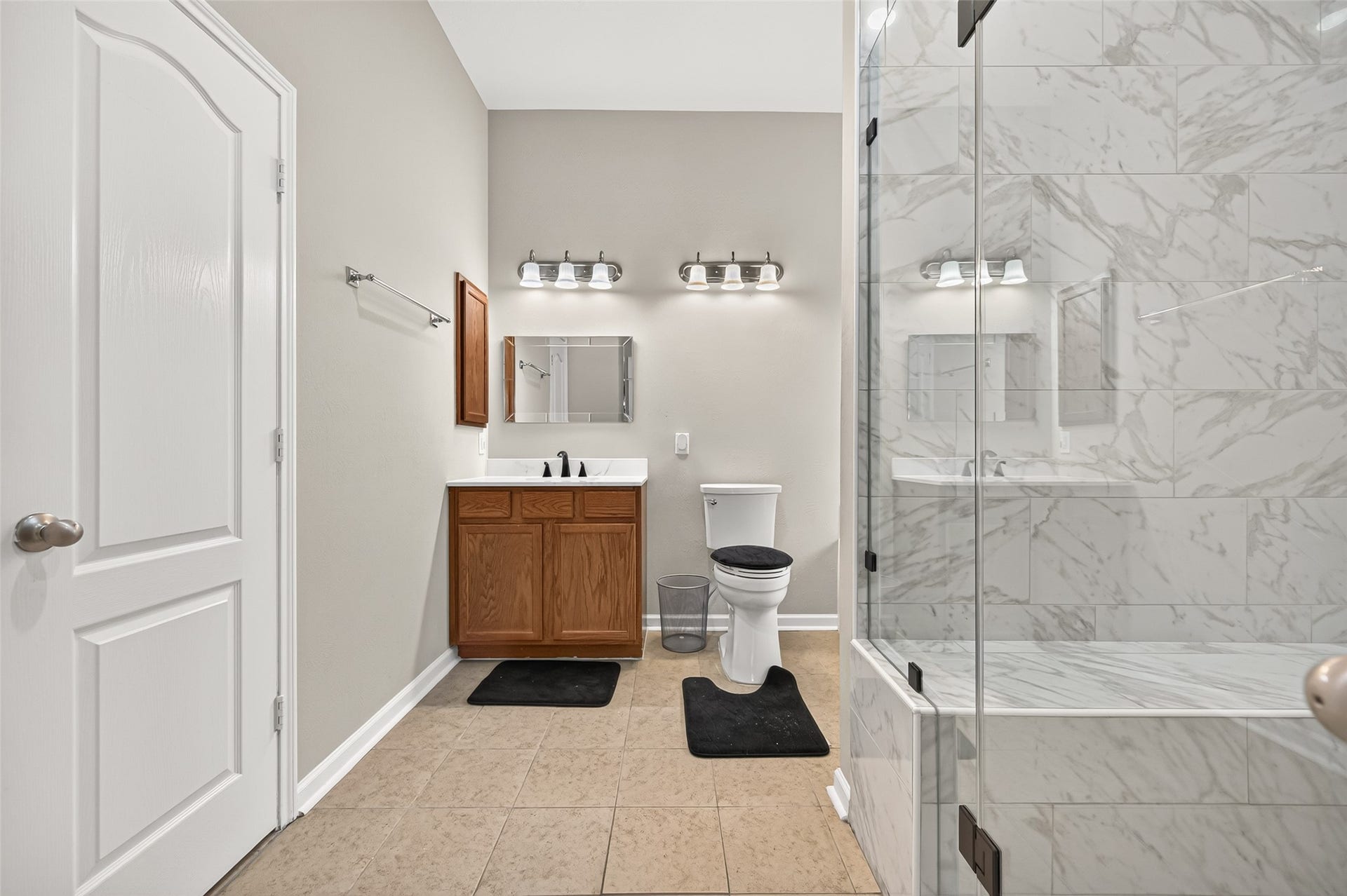 9307 Russeff Field Lane, Rosenberg, TX 77469 Primary bathroom featuring a separate soaking tub, glass-enclosed shower, and decorative tile finishes.