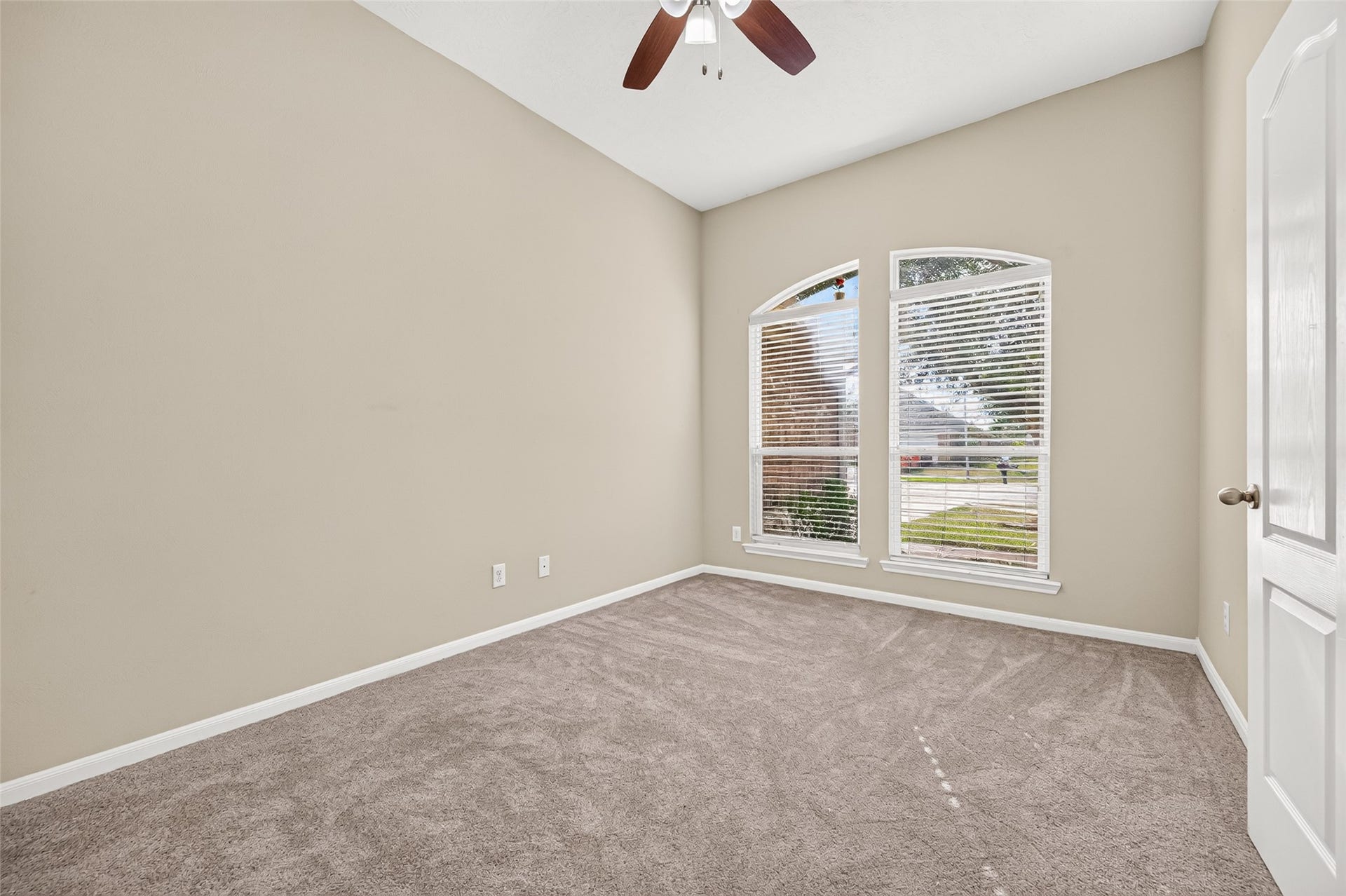 9307 Russeff Field Lane, Rosenberg, TX 77469 Secondary bedroom featuring a vaulted ceiling, ceiling fan, neutral carpeting, and a window providing natural light.