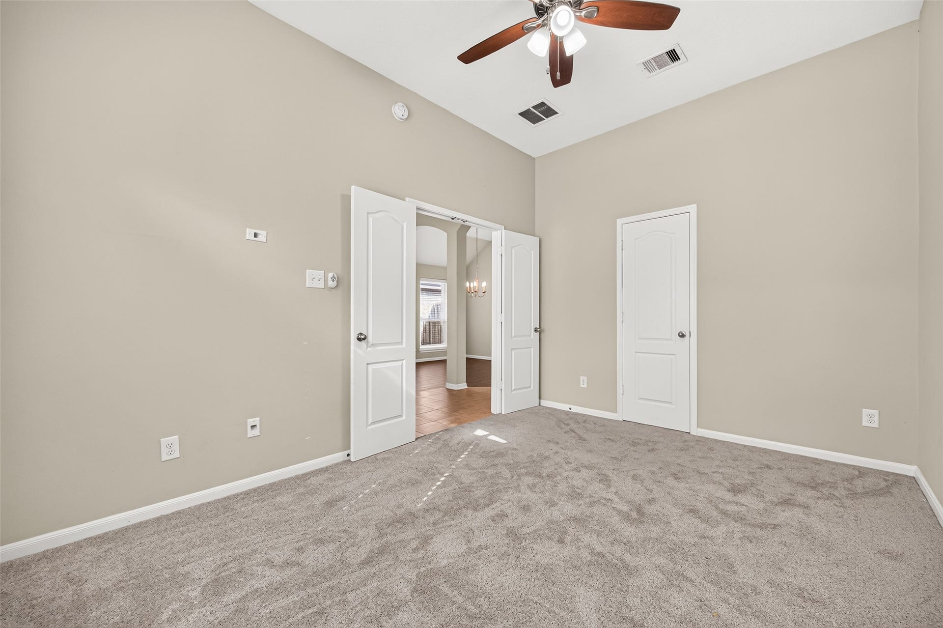 9307 Russeff Field Lane, Rosenberg, TX 77469 Additional view of the secondary bedroom showcasing its vaulted ceiling, neutral finishes, and adjoining doorway.